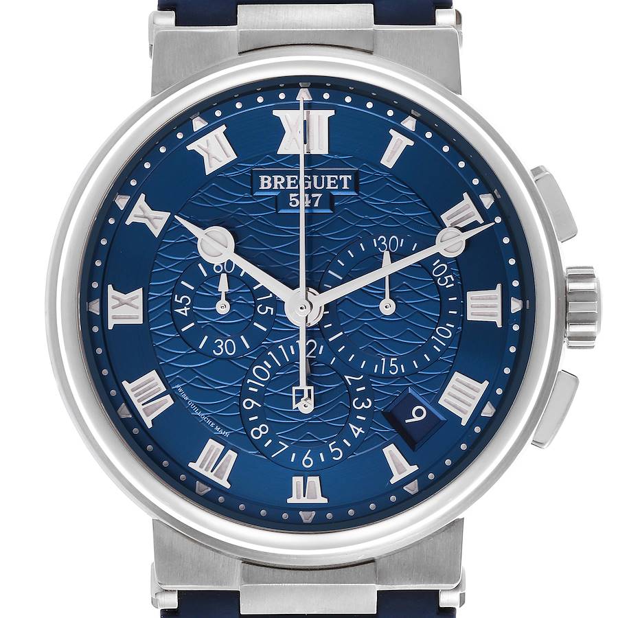 The Breguet Marine watch is shown from a front angle, highlighting its blue textured dial and chronograph features.