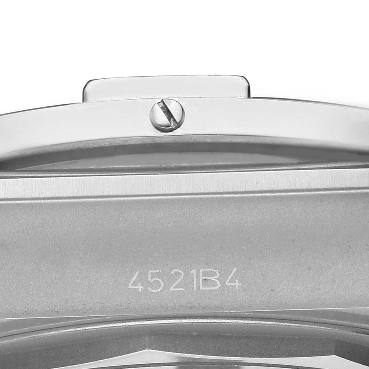 The image shows a close-up of the casing and bezel side of a Breitling Chronomat AB0134 Men's Stainless Steel Silver Dial watch, focusing on the serial number and a screw.