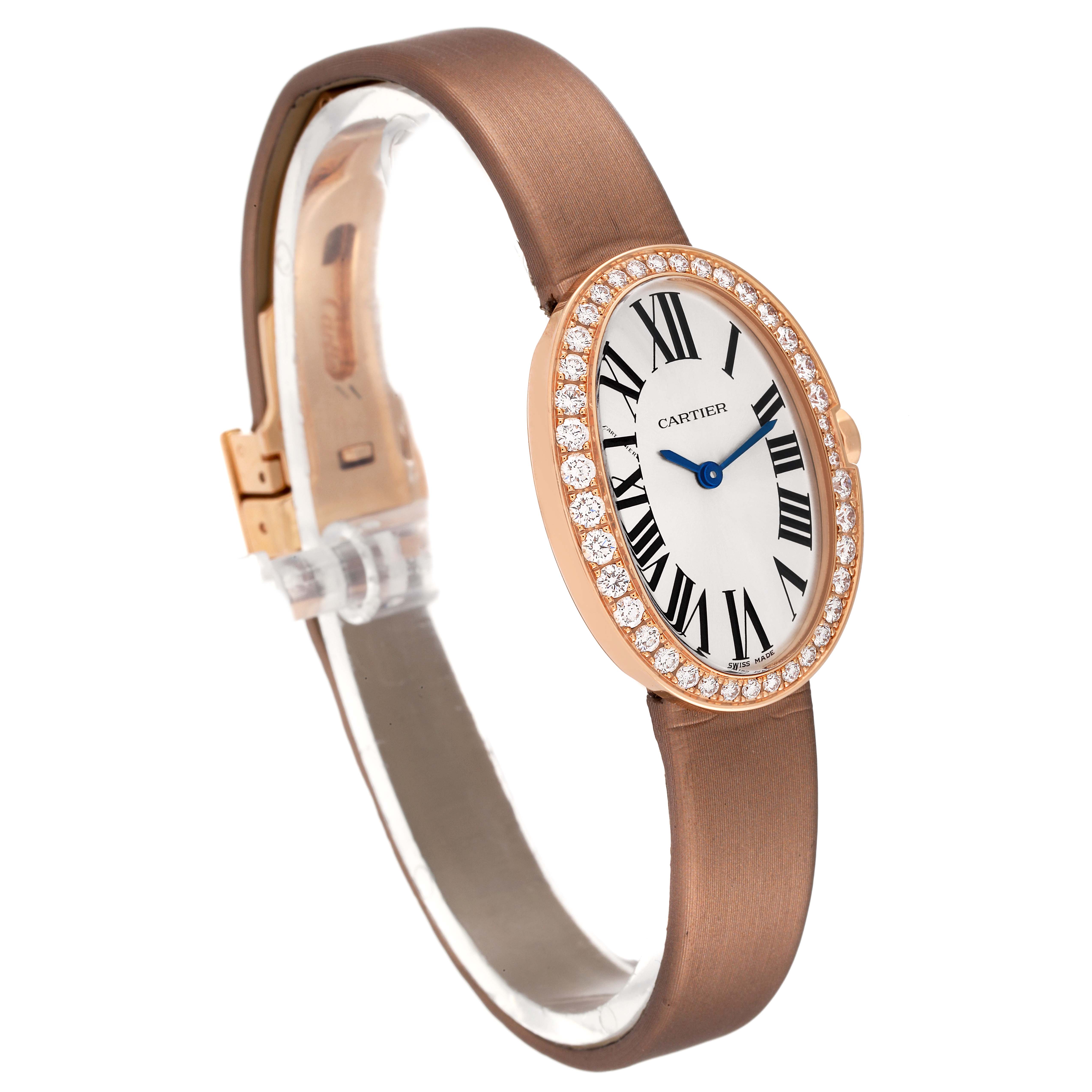 The image displays a front-left angled view of a Cartier Baignoire WB520004 Women's Rose Gold Silver Dial WB520004 Women's Rose Gold Silver Dial watch, highlighting its oval face, Roman numerals, diamond bezel, and brown strap.