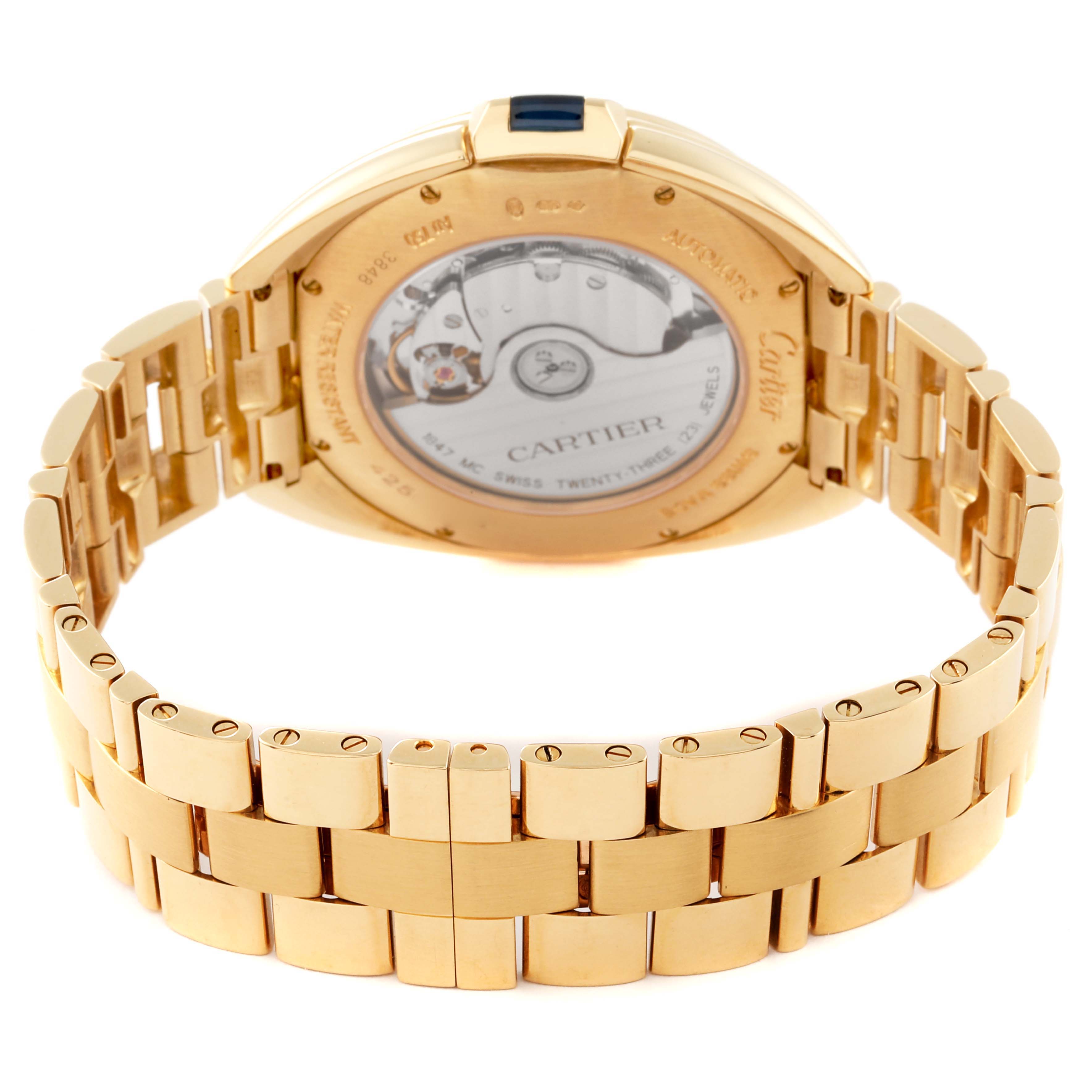 The image shows the back view of a Cartier Clé model watch, highlighting its gold bracelet and transparent case back.