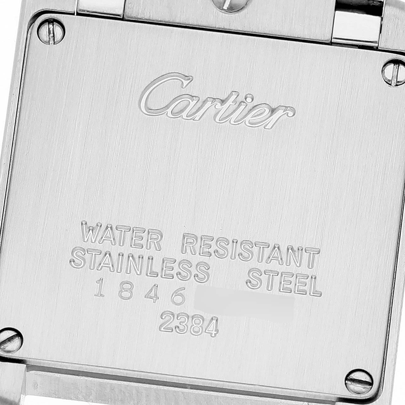 This image shows the back case of a Cartier Tank Française watch engraved with specifications.