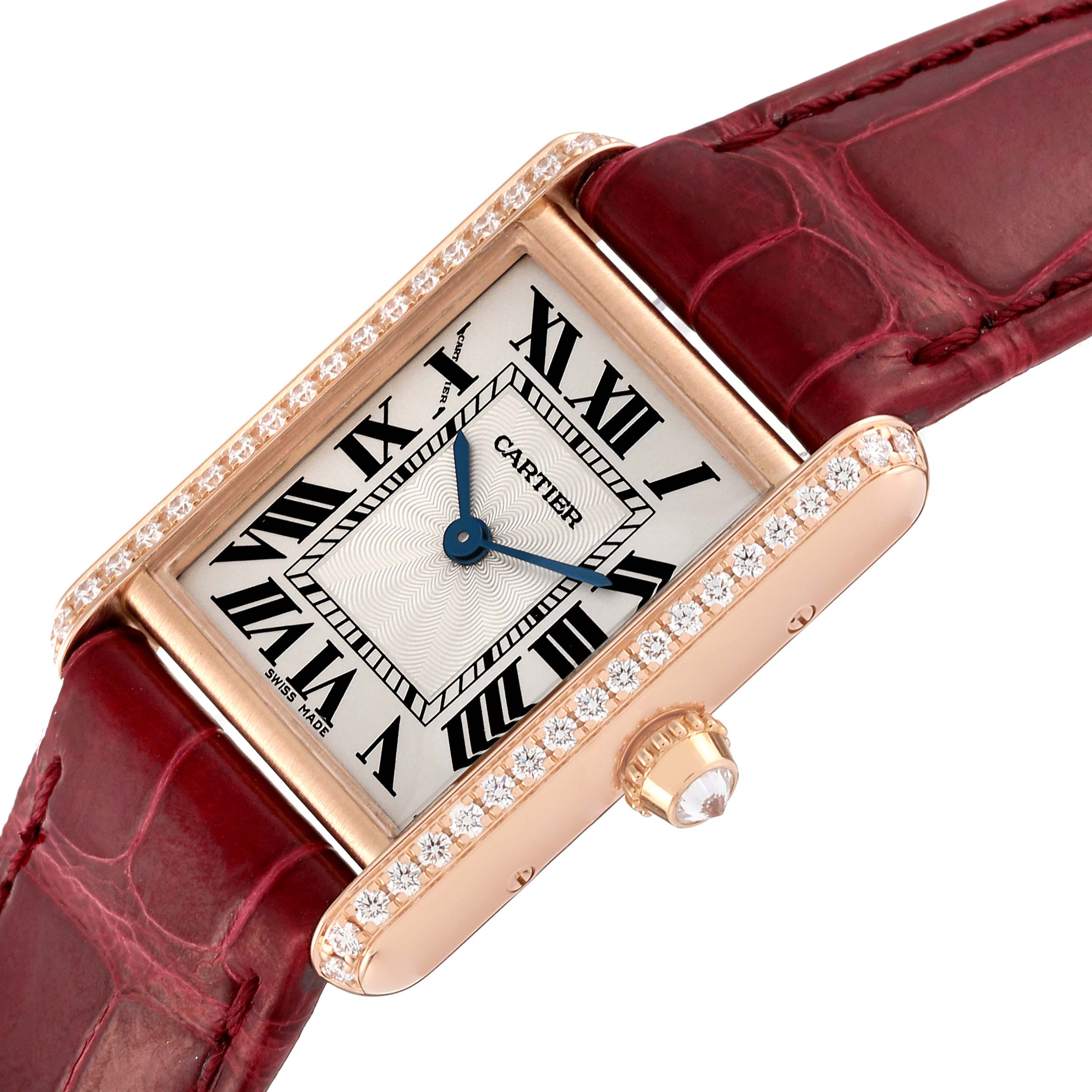 The Tank Louis model by Cartier is shown at an angled close-up, highlighting the watch face, red strap, and bejeweled case.