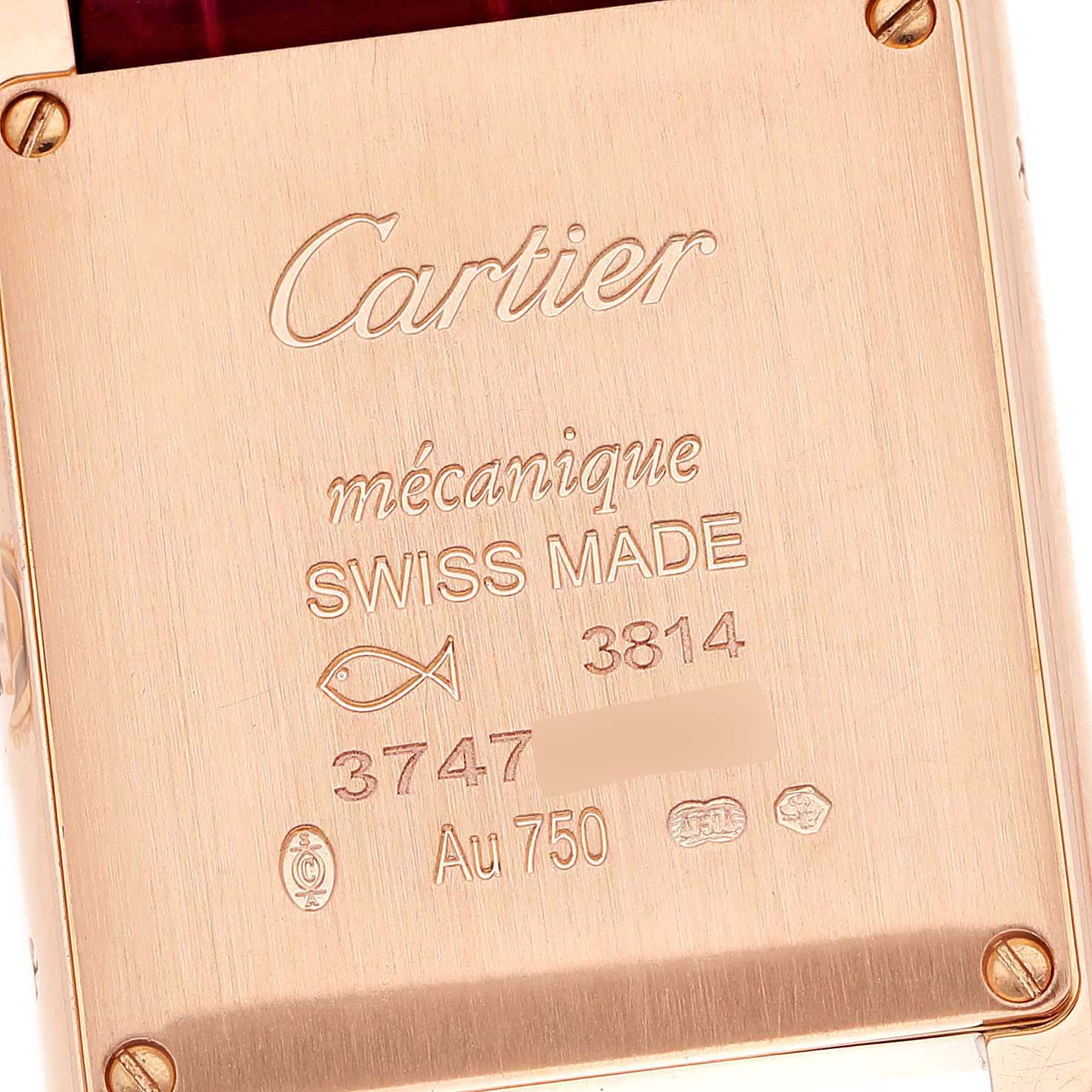 This image shows the back of a Tank Louis watch by Cartier, highlighting the engravings and gold details.