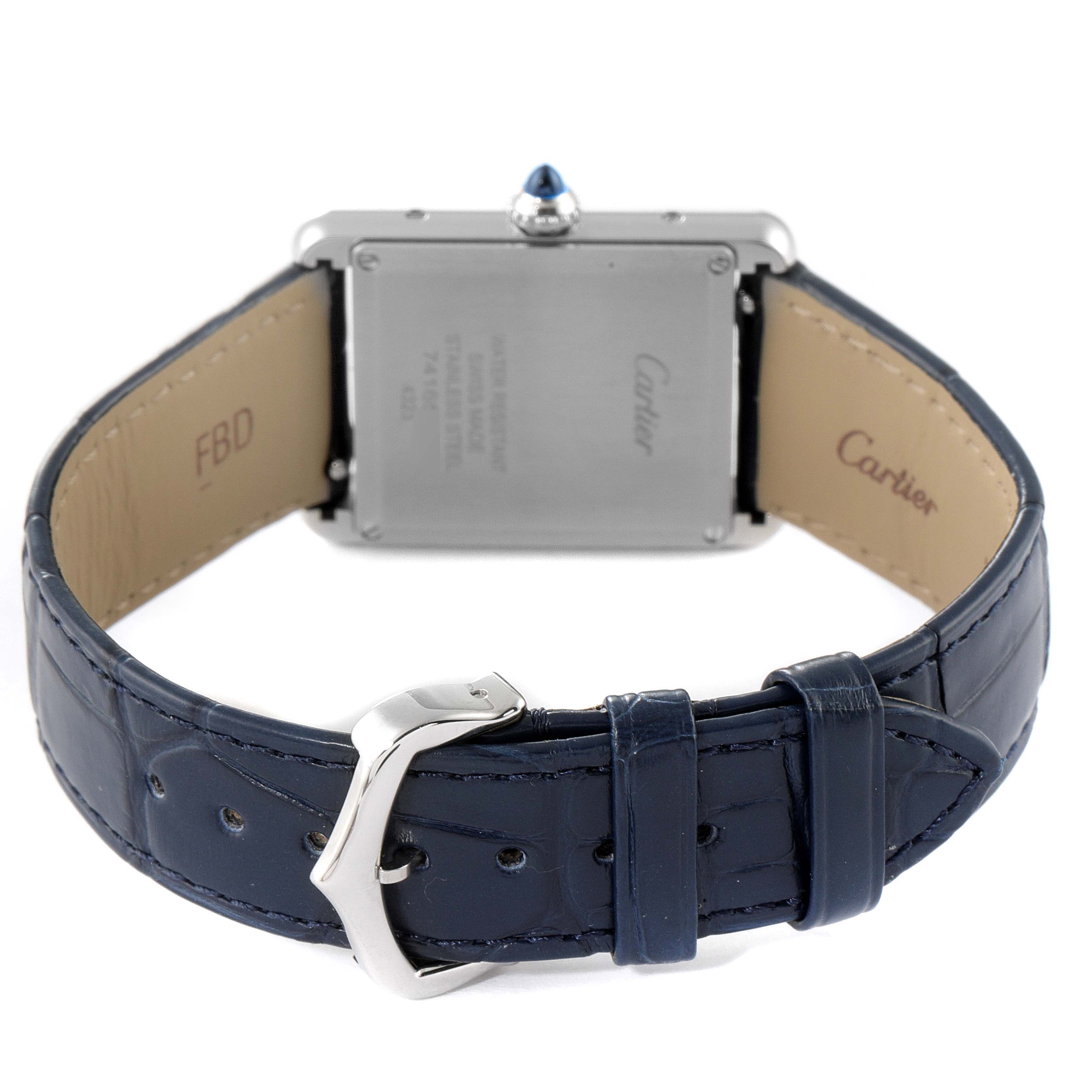 The image shows the back view of a Cartier Tank Must WSTA0055 Men's Stainless Steel Blue Dial WSTA0055 Men's Stainless Steel Blue Dial watch, highlighting its blue leather strap and steel caseback.