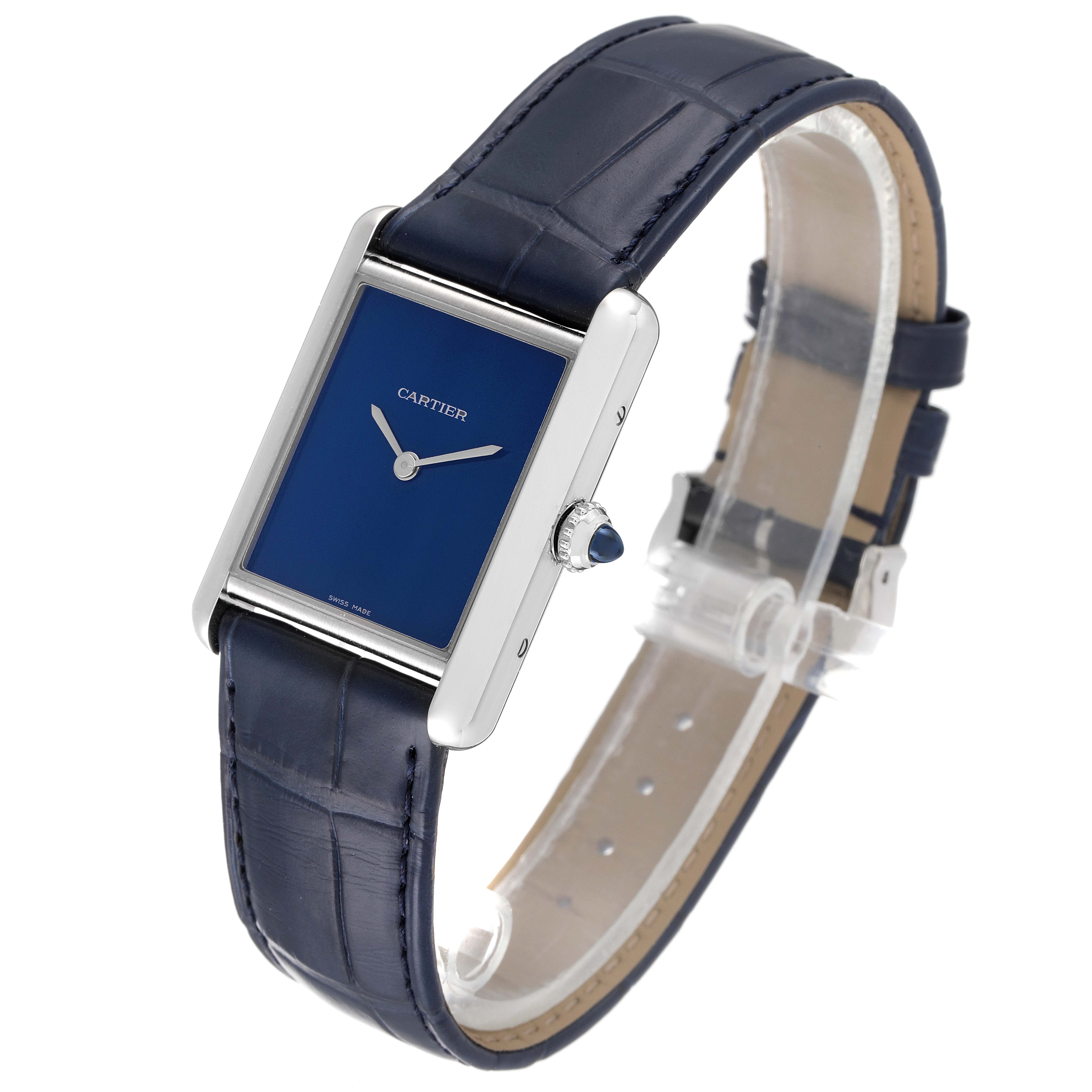 The image shows a Cartier Tank Must WSTA0055 Men's Stainless Steel Blue Dial WSTA0055 Men's Stainless Steel Blue Dial watch at an angle highlighting its blue face, silver case, and blue leather strap.