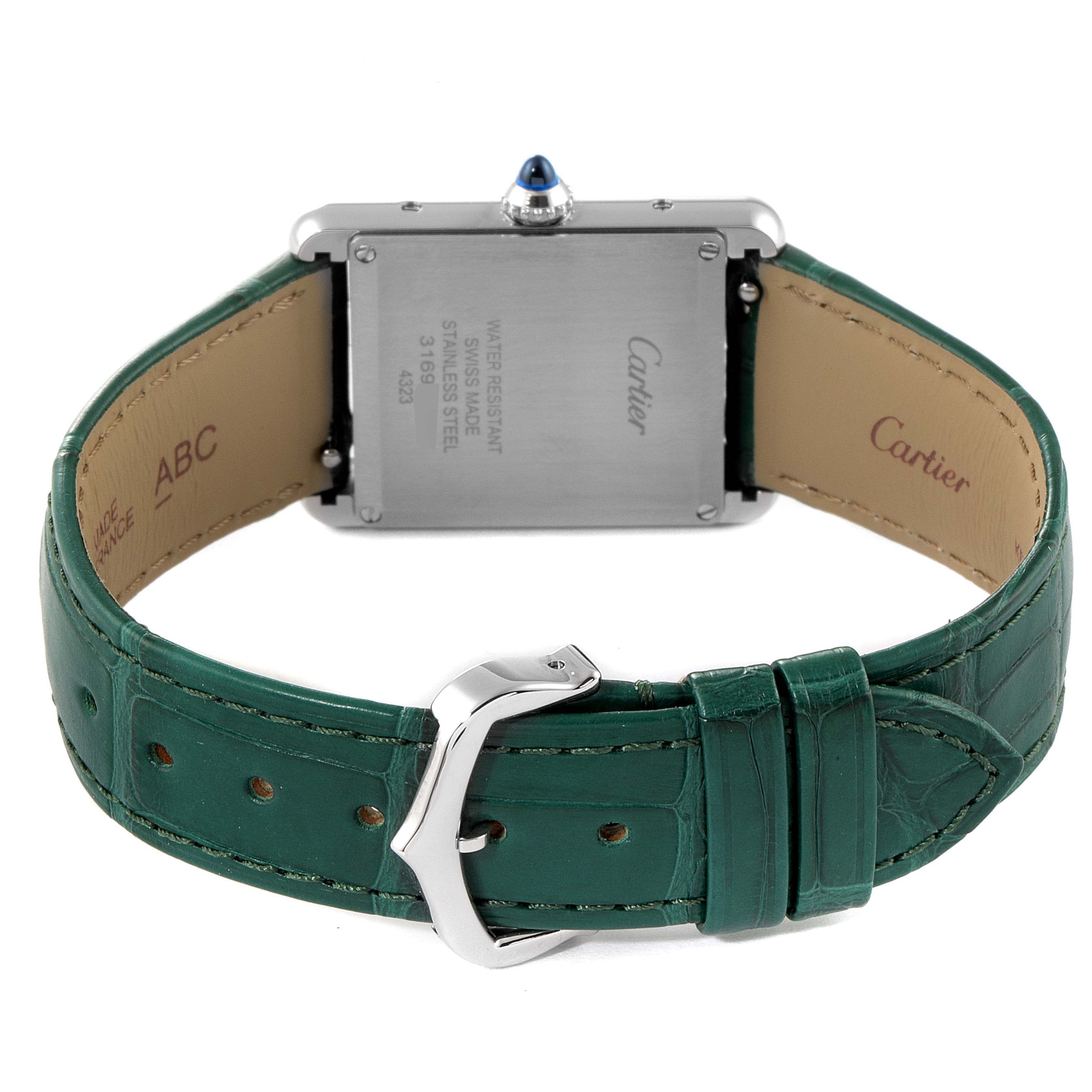 The image shows the back view of a Cartier Tank Must WSTA0056 Women's Stainless Steel Green Dial WSTA0056 Women's Stainless Steel Green Dial watch, featuring its case back, green leather strap, and buckle.
