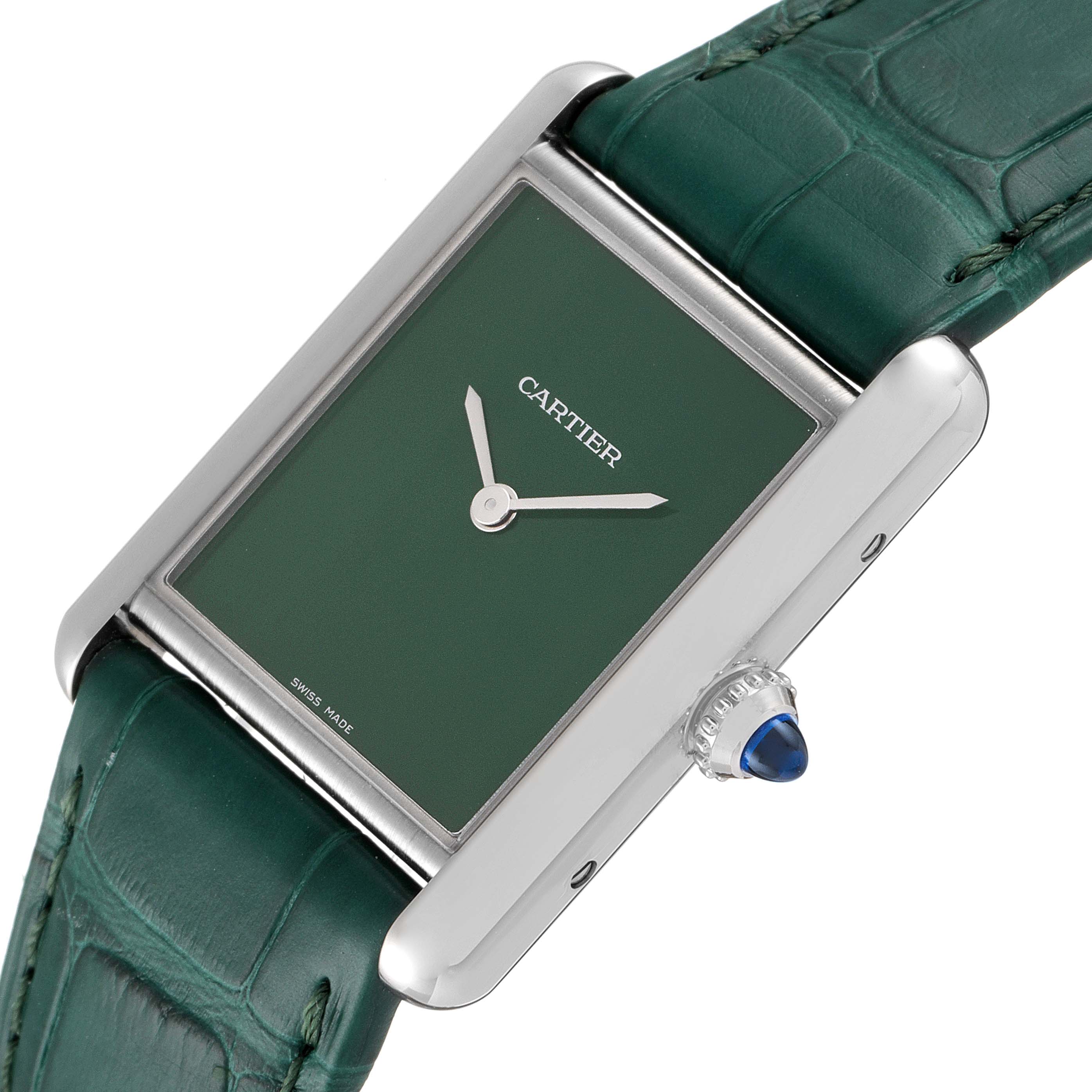 The image shows a Cartier Tank Must WSTA0056 Women's Stainless Steel Green Dial WSTA0056 Women's Stainless Steel Green Dial watch at an angled close-up, highlighting the green dial, silver case, and crown with a blue cabochon.