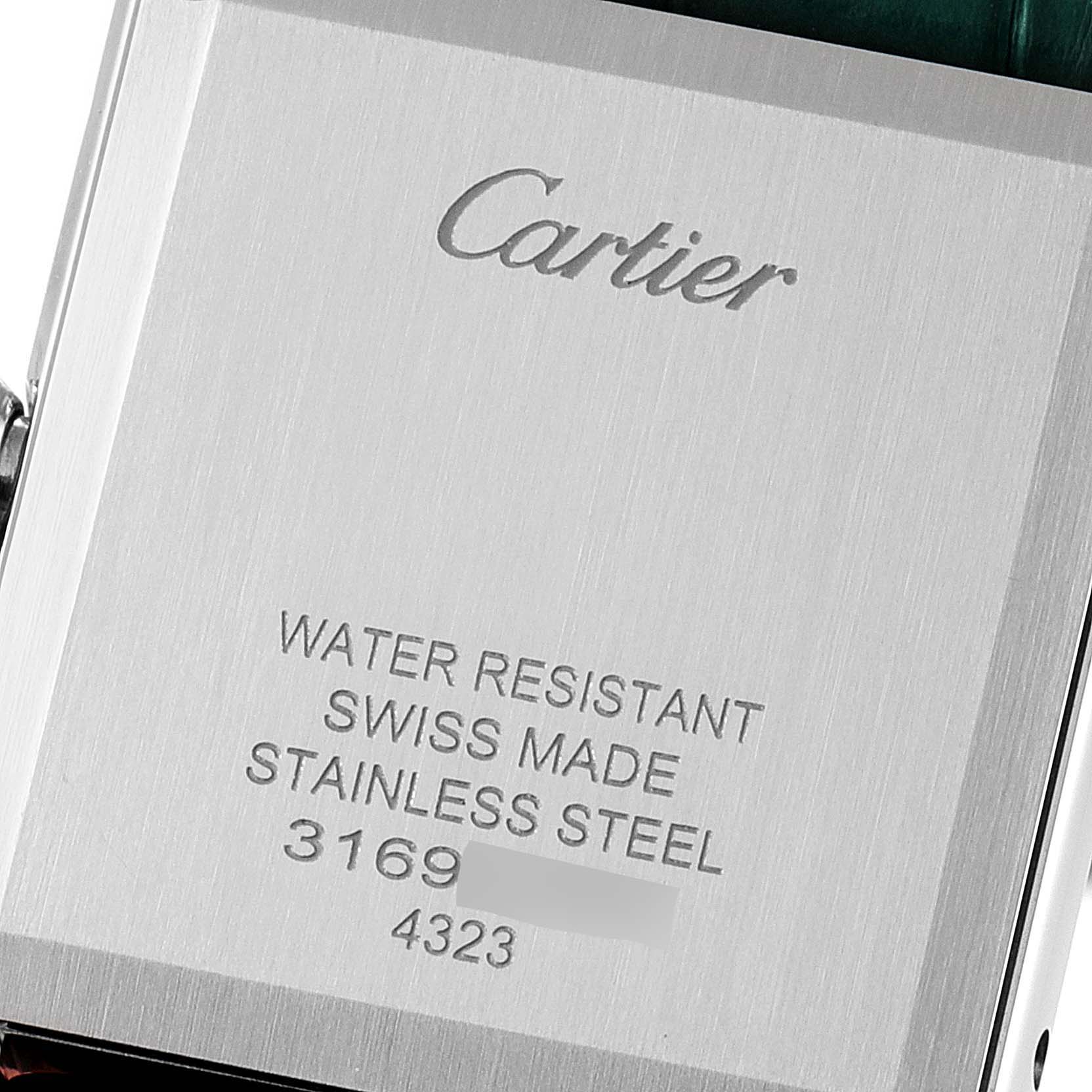 This image shows the back case of a Cartier Tank Must WSTA0056 Women's Stainless Steel Green Dial WSTA0056 Women's Stainless Steel Green Dial watch, highlighting the water resistance, material, and serial numbers.