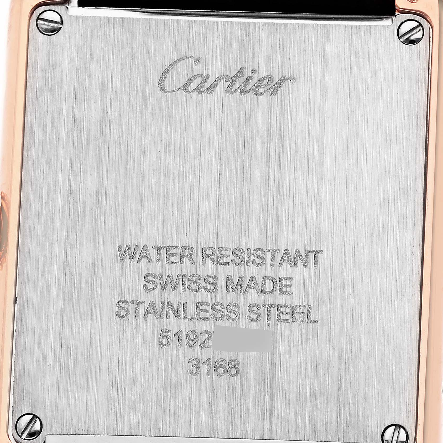 The image shows the back case of the Cartier Tank Solo W5200024 Women's Steel and Gold (two tone) Silver Dial W5200024 Women's Steel and Gold (two tone) Silver Dial watch, highlighting engravings and screws.