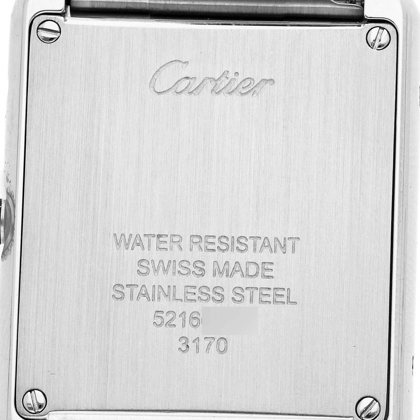 The image shows the back of a Cartier Tank Solo W5200013 Women's Stainless Steel Silver Dial watch, highlighting the brand logo and specifications.