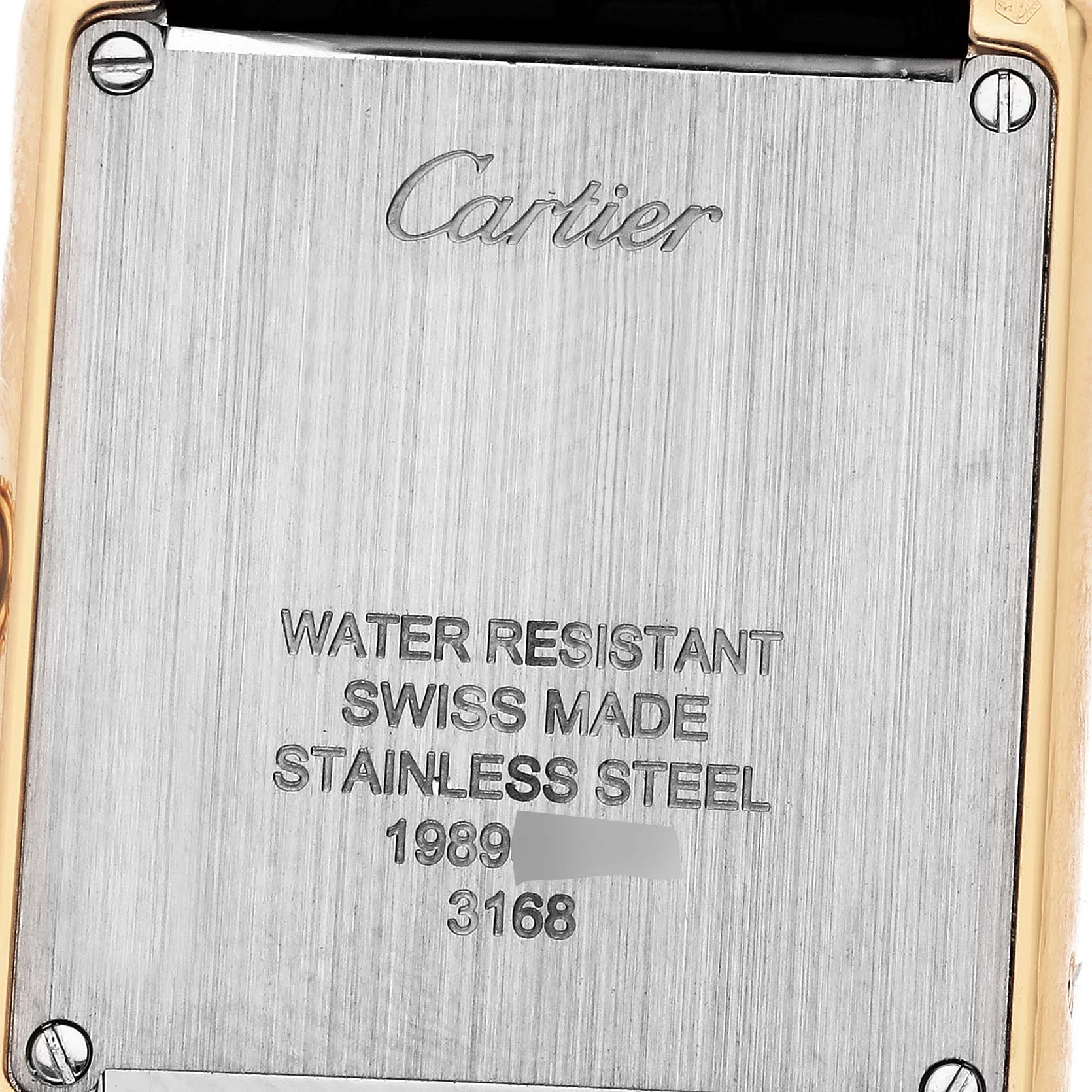 The image shows the back case of a Cartier Tank Solo W5200002 Women's Steel and Gold (two tone) Silver Dial W5200002 Women's Steel and Gold (two tone) Silver Dial watch, highlighting the engraved text details.