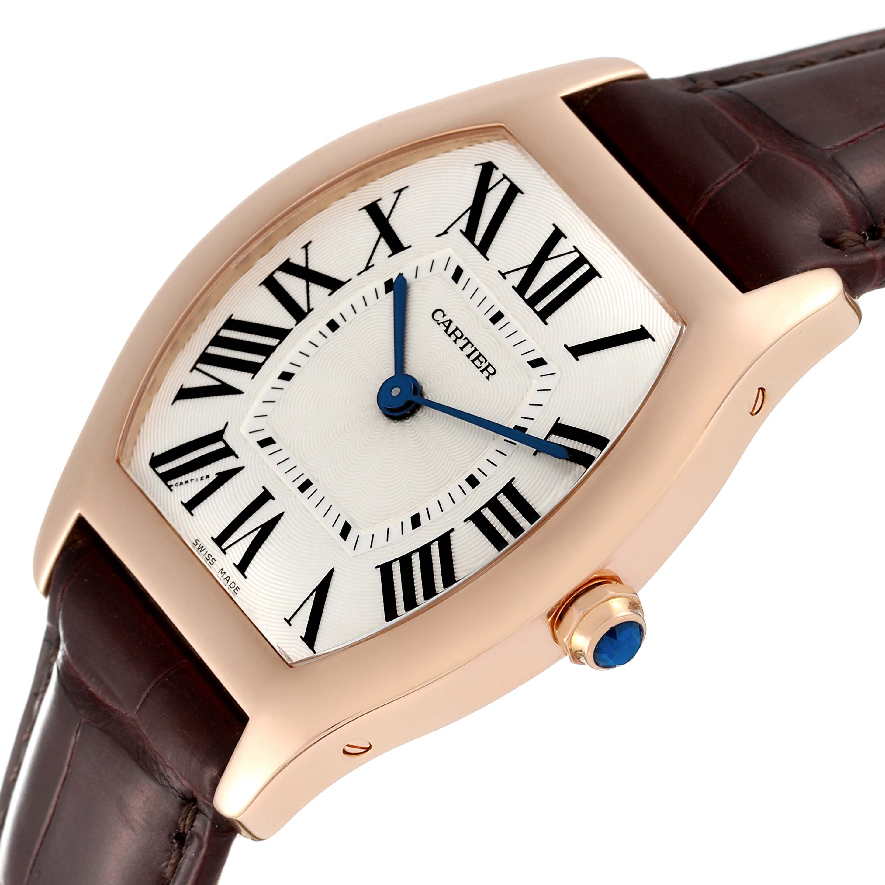 The Cartier Tortue W1556362 Men's Rose Gold Silver Dial W1556362 Men's Rose Gold Silver Dial watch is angled from the right, showing its Roman numeral dial, blue hands, and brown leather strap.