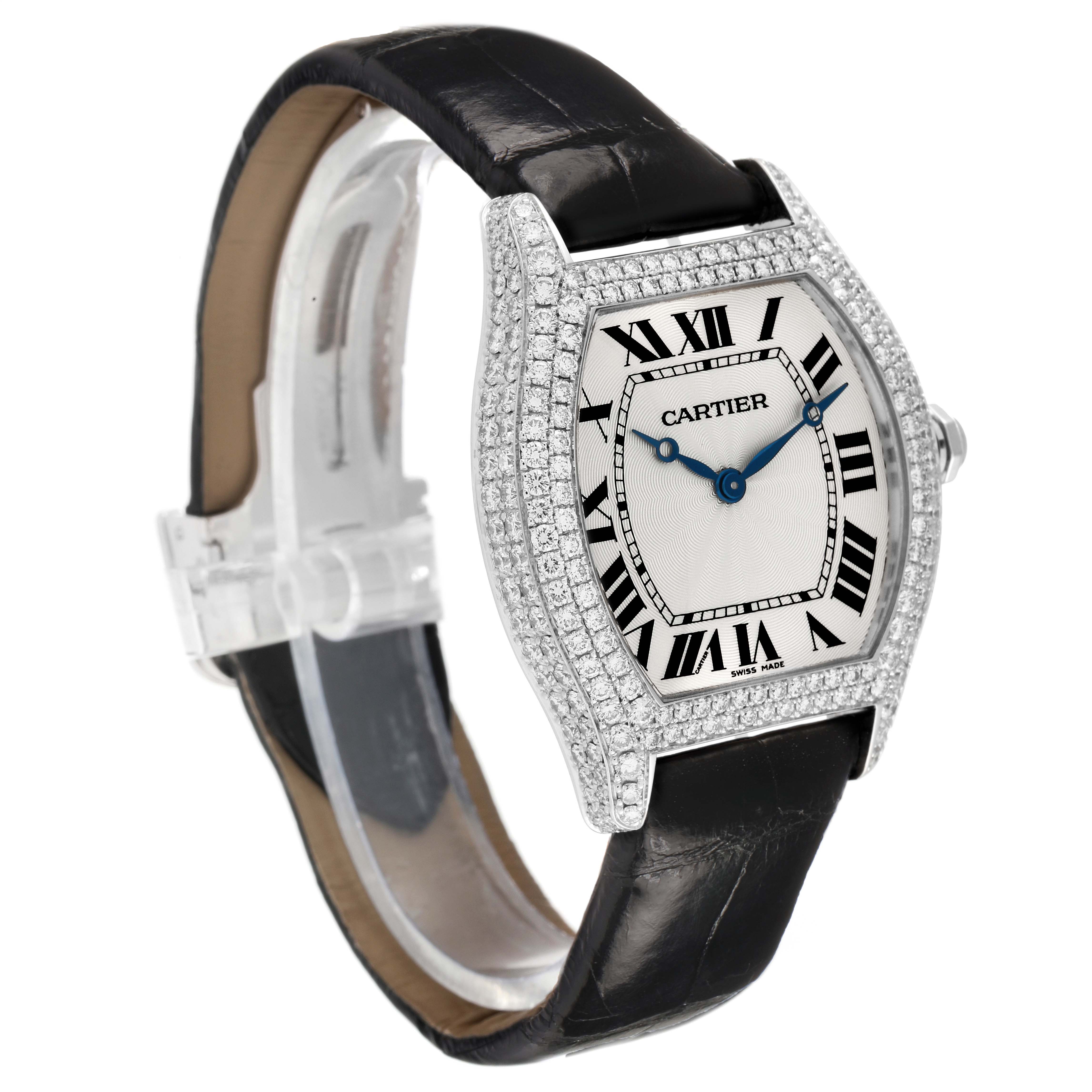 The Cartier Tortue WA504351 Men's White Gold Silver Dial watch is shown at a three-quarter angle, displaying its diamond-encrusted case, Roman numeral dial, and leather strap.