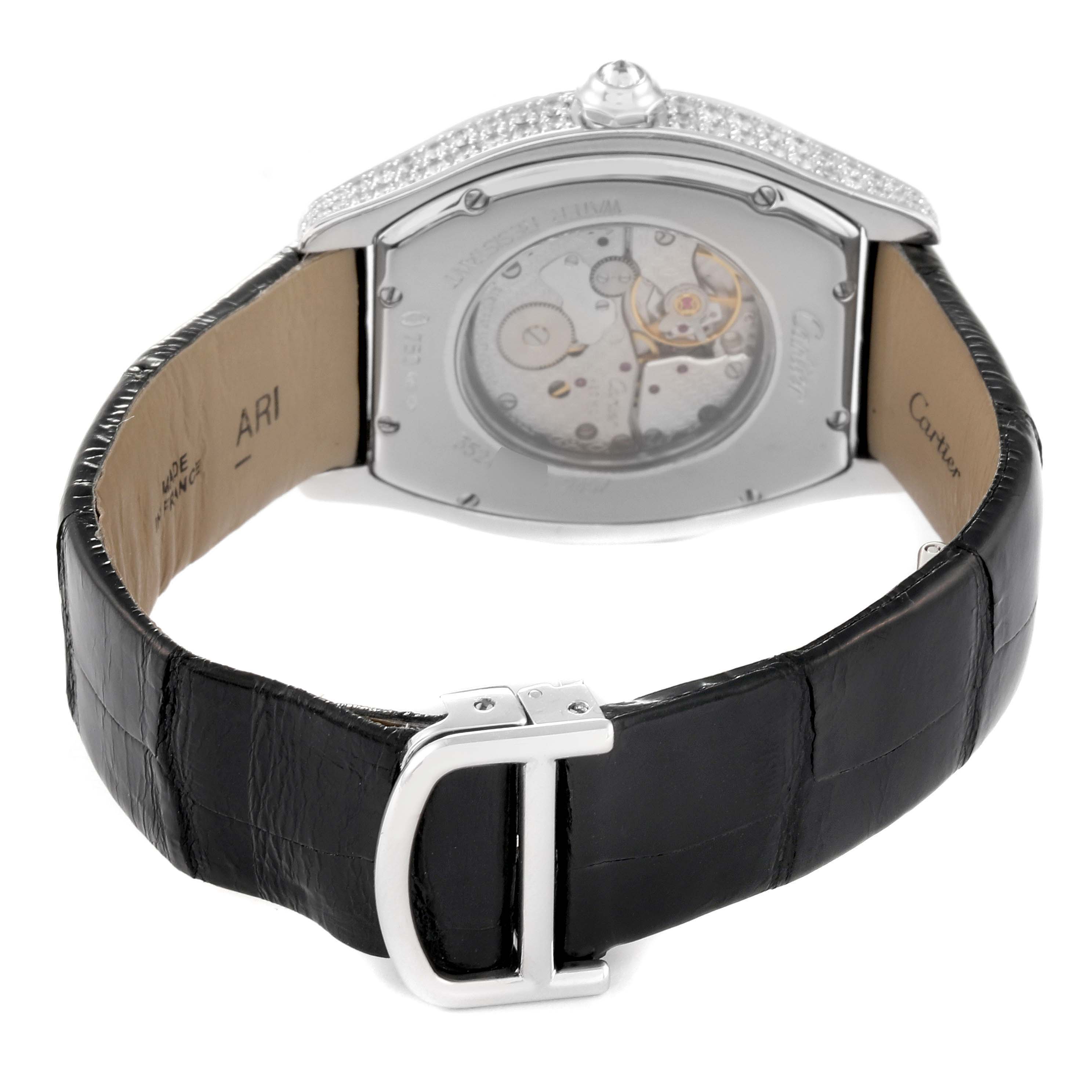 The Cartier Tortue WA504351 Men's White Gold Silver Dial watch is shown from the back, highlighting its see-through case back, strap, and buckle.