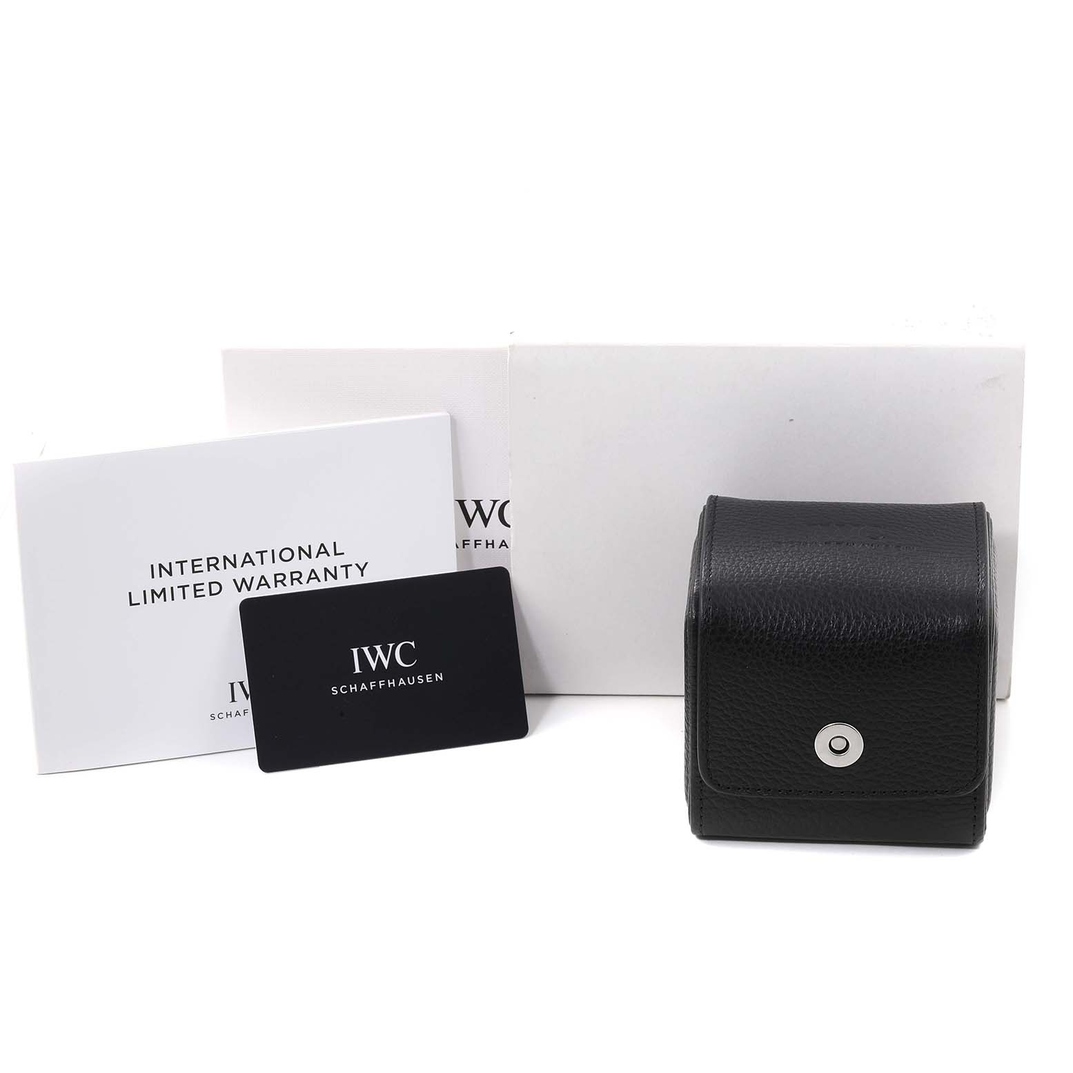 This image shows the IWC Pilot IW388104 Men's Stainless Steel Green Dial IW388104 Men's Stainless Steel Green Dial model watch accessories including warranty cards, a black box, and their packaging.