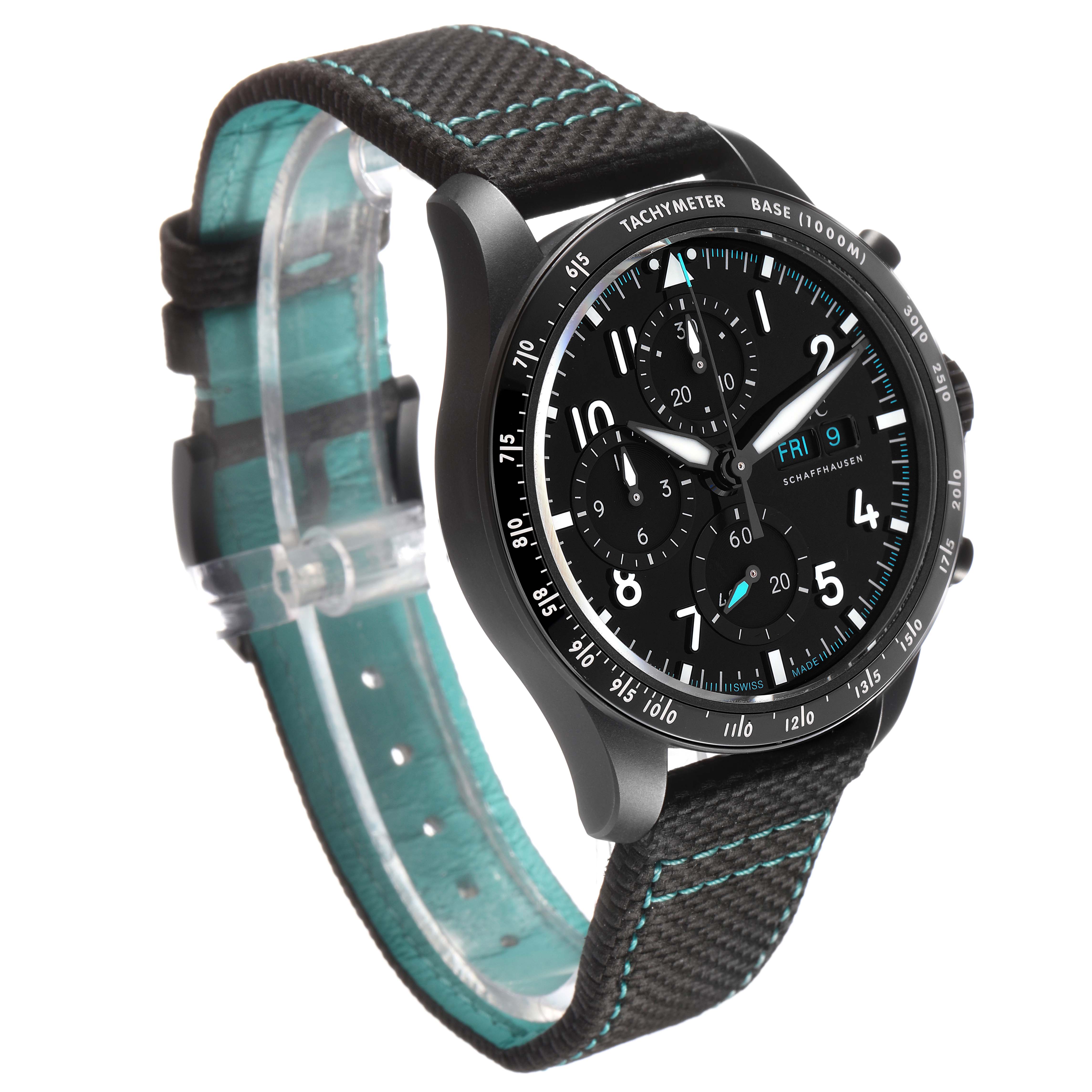 The IWC Pilot IW388306 Men's Ceramic Black Dial model watch is shown at an angled side view, highlighting the dial, tachymeter, and strap with blue stitching.