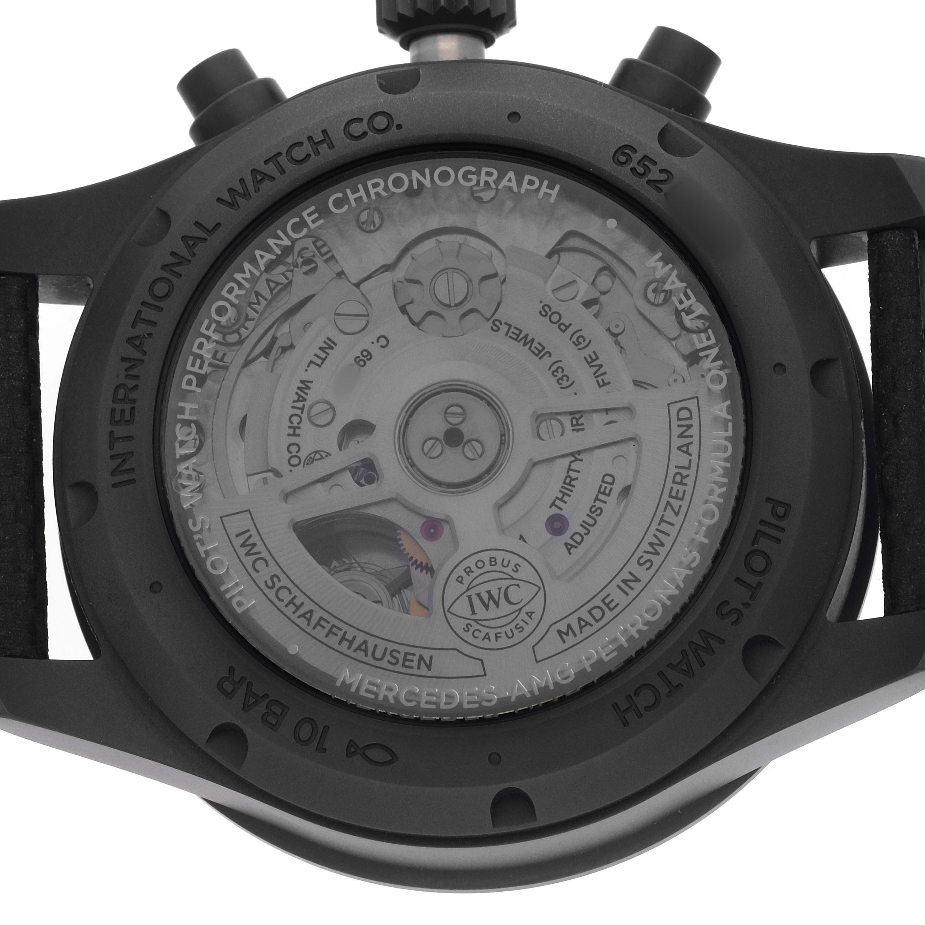 The image shows the back of the IWC Pilot IW388306 Men's Ceramic Black Dial model watch, highlighting its movement and chronograph details.