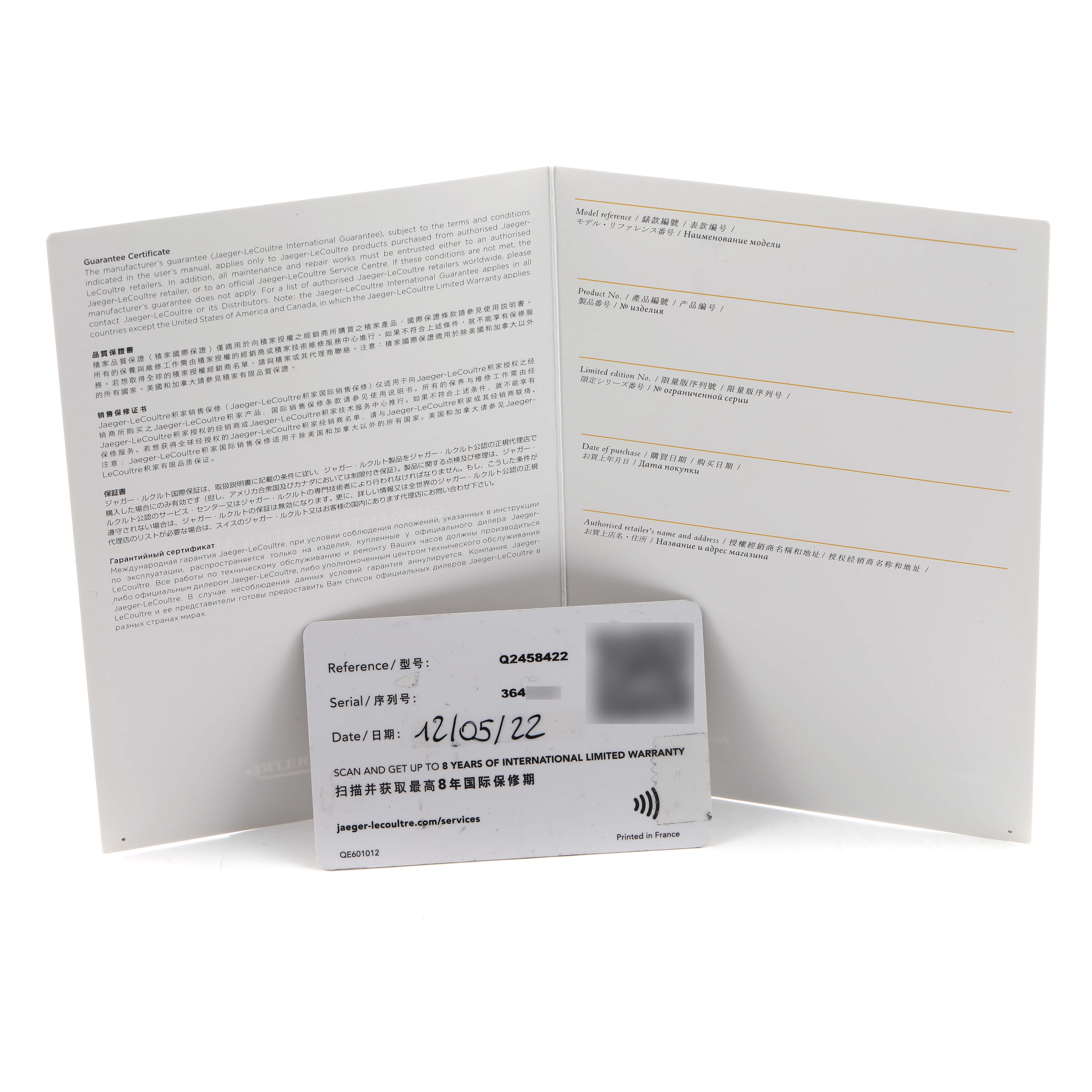 The image shows warranty cards and a booklet for a Jaeger LeCoultre Reverso Q2458422 Men's Stainless Steel Silver Dial, displayed at an angle to emphasize the documents.