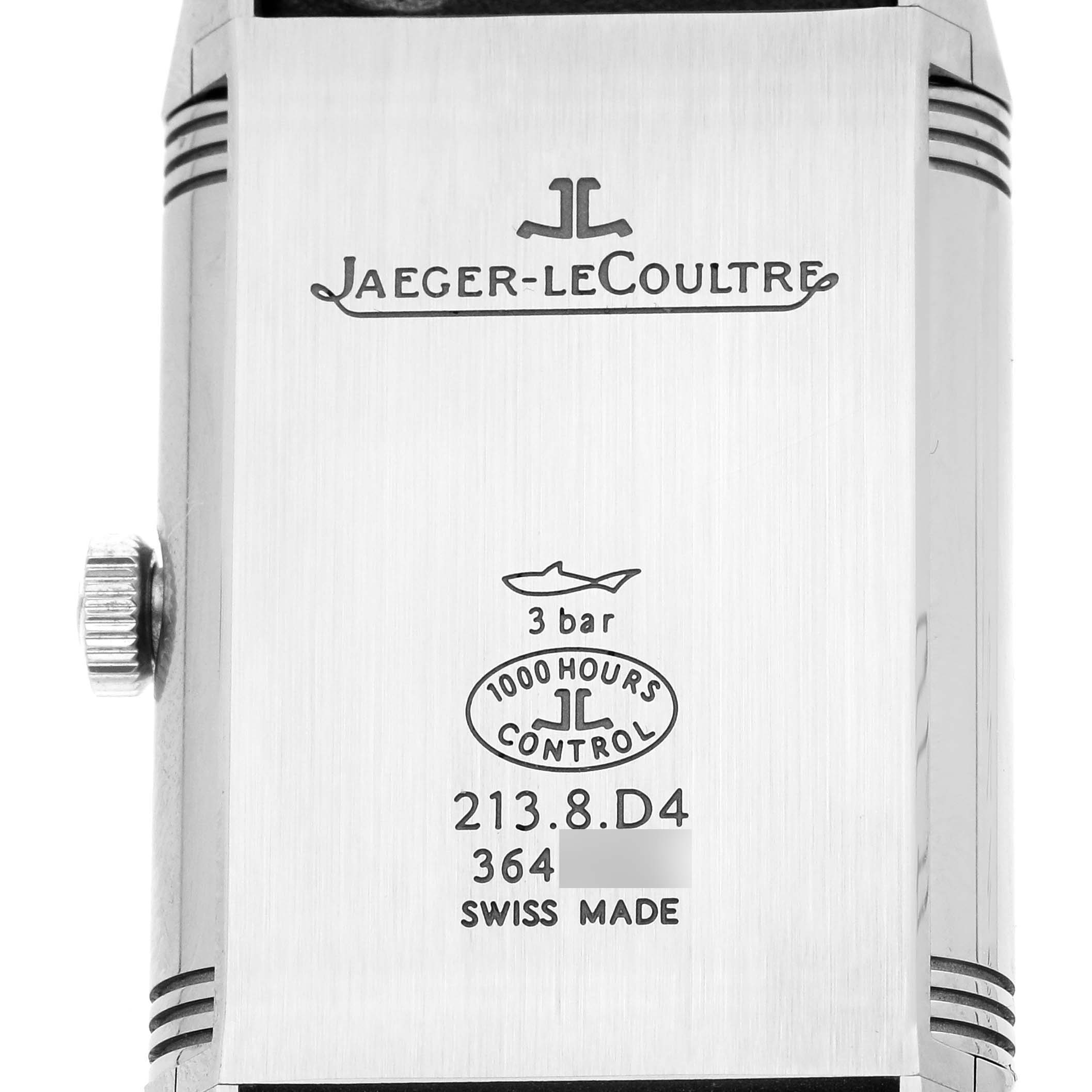 The image shows the back of the Jaeger-LeCoultre Reverso watch, highlighting its engravings and crown.