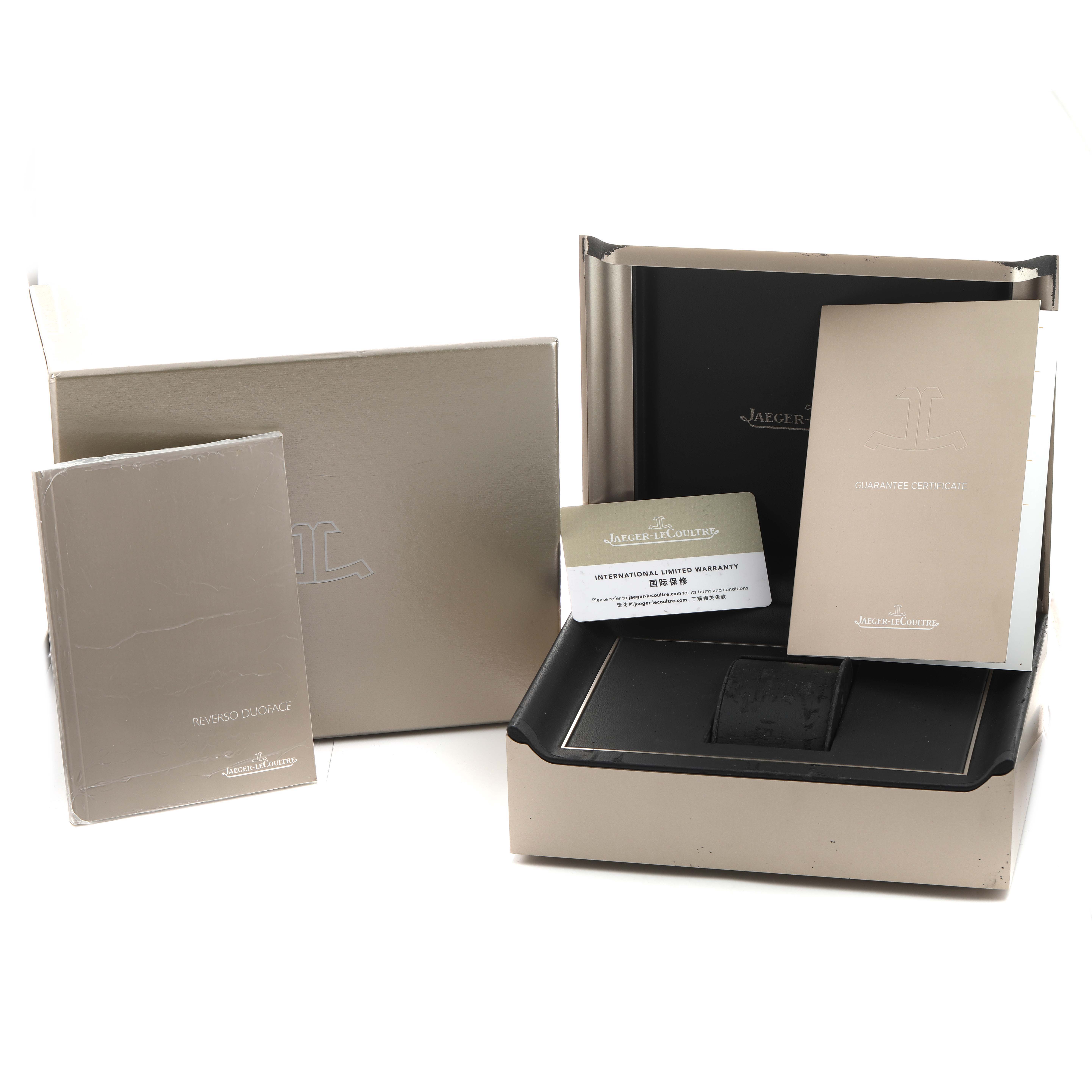 The image shows a Jaeger-LeCoultre Reverso watch set with packaging, manuals, guarantee certificate, and warranty card.