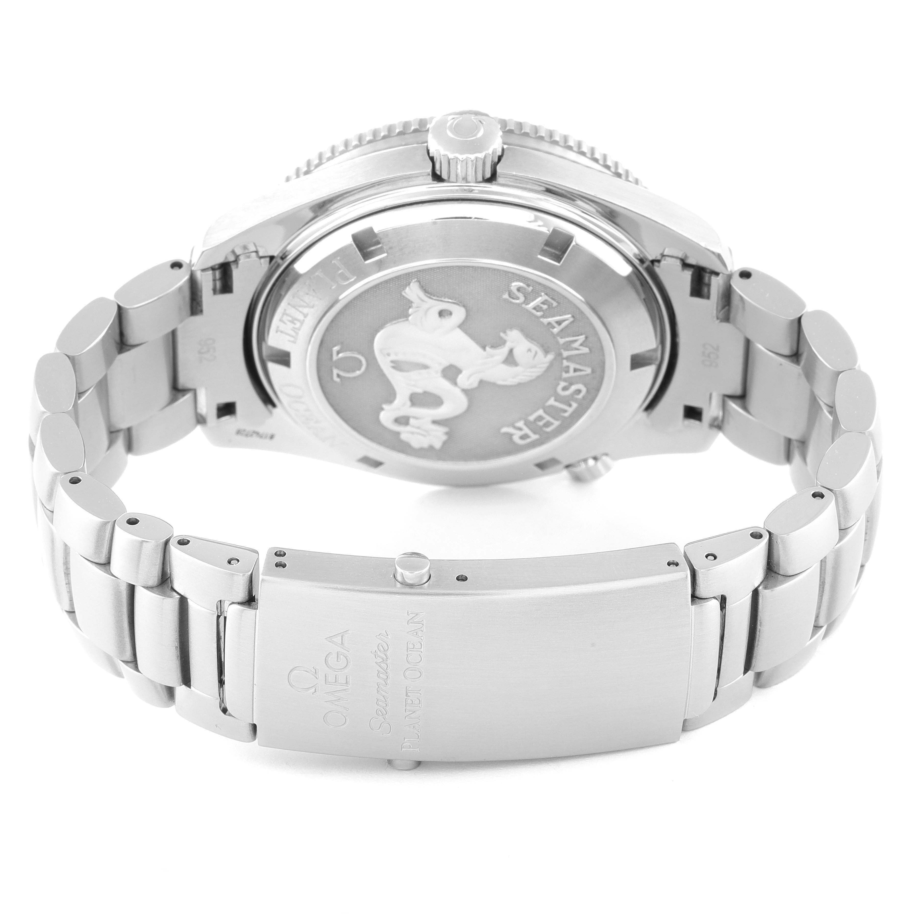 The image shows the back and clasp of the Omega Seamaster Planet Ocean watch, highlighting its metal bracelet and engraved case back.