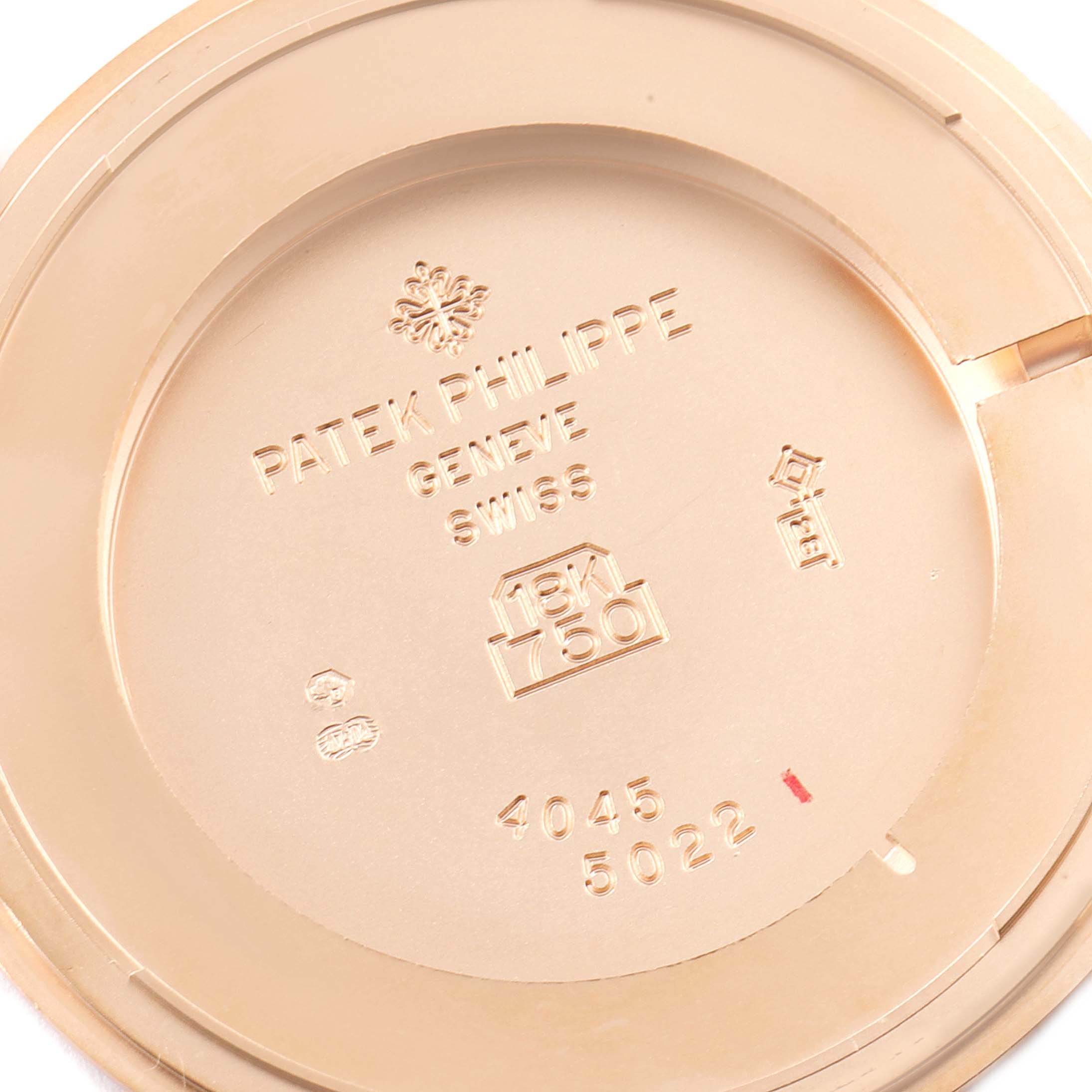 This image shows the inside case back of a Patek Philippe Calatrava 5022R Men's Rose Gold White Dial 5022R Men's Rose Gold White Dial watch, highlighting engraving details including the brand and gold content.