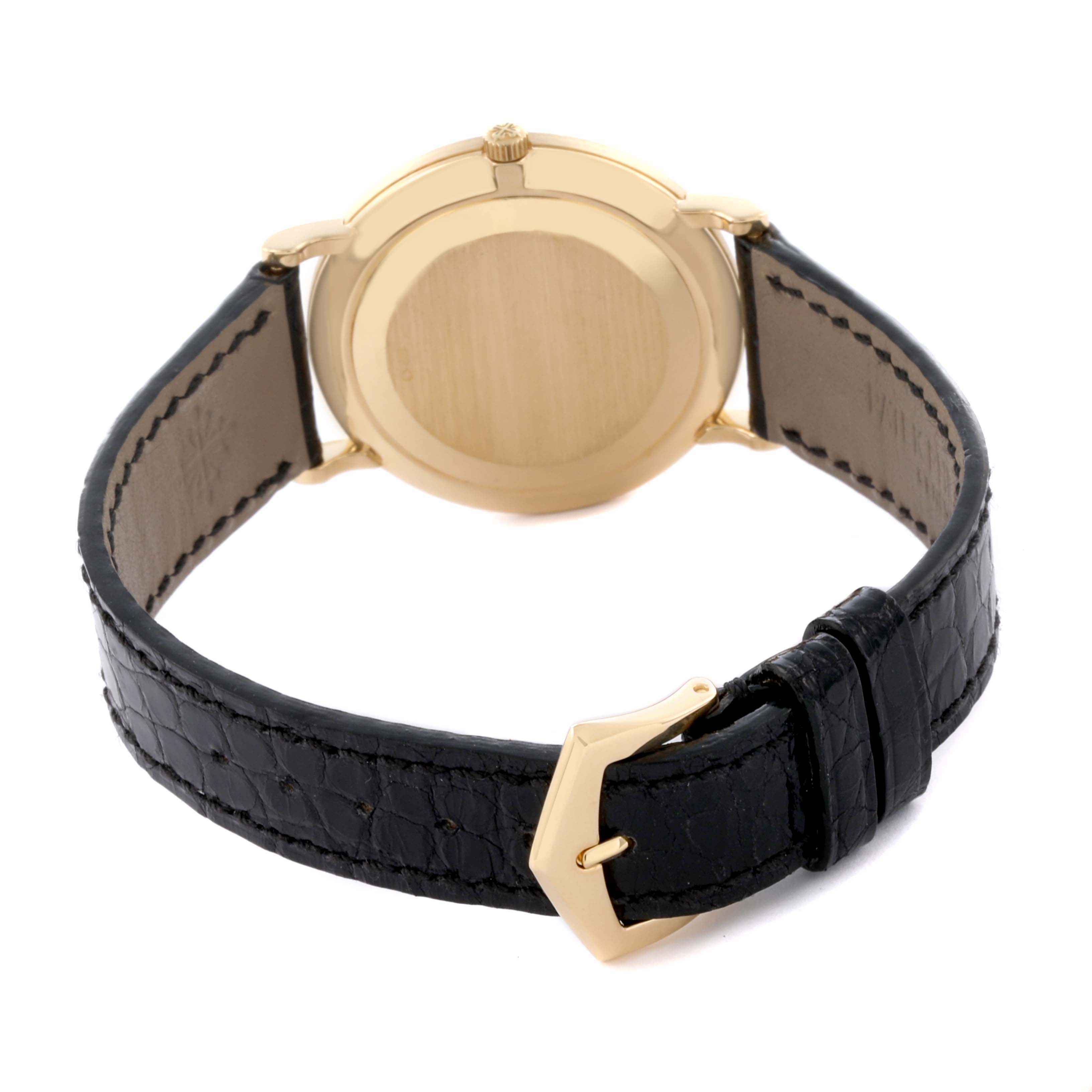 The image shows a rear view of the Patek Philippe Calatrava 3919J Men's Yellow Gold White Dial 3919J Men's Yellow Gold White Dial watch, highlighting the case back and leather strap with a gold buckle.