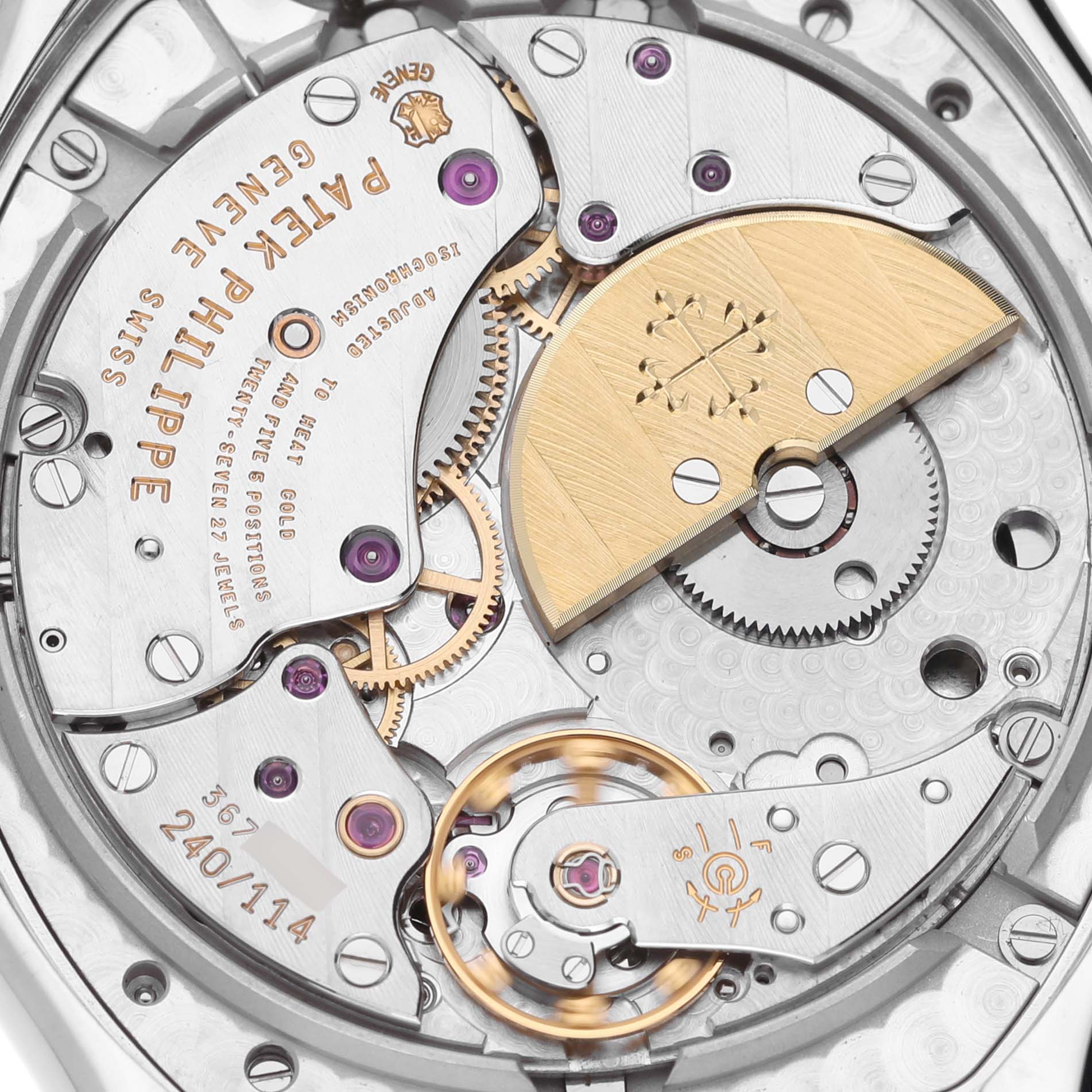 The image shows a close-up of the movement of the Patek Philippe Complications 5040G Men's White Gold Silver Dial 5040G Men's White Gold Silver Dial model, highlighting gears and a gold rotor.
