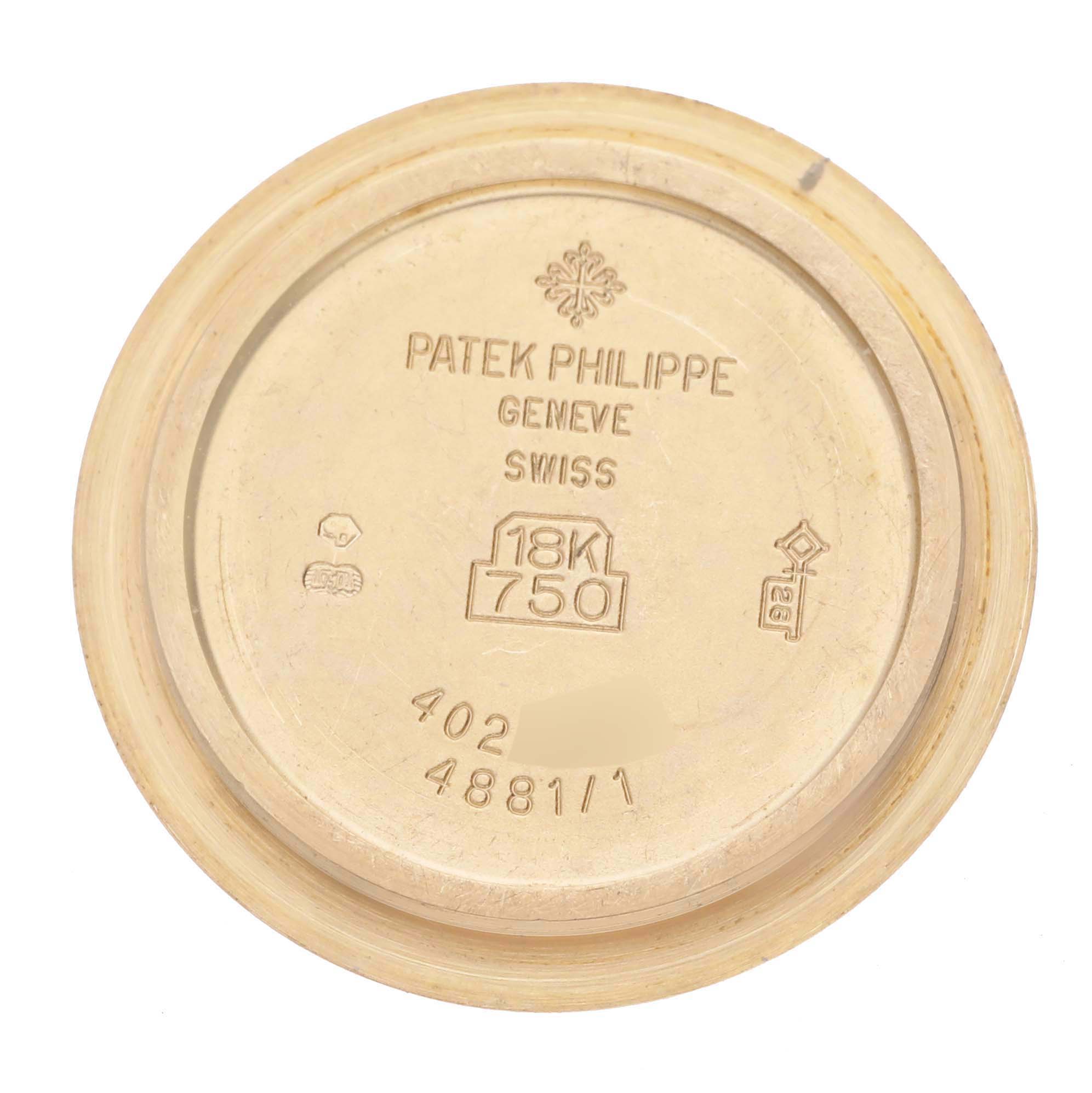 The image shows the inner case back of a Patek Philippe Neptune 4881/1J-001 Women's Yellow Gold Silver Dial 4881/1J-001 Women's Yellow Gold Silver Dial watch, engraved with logos and material information.