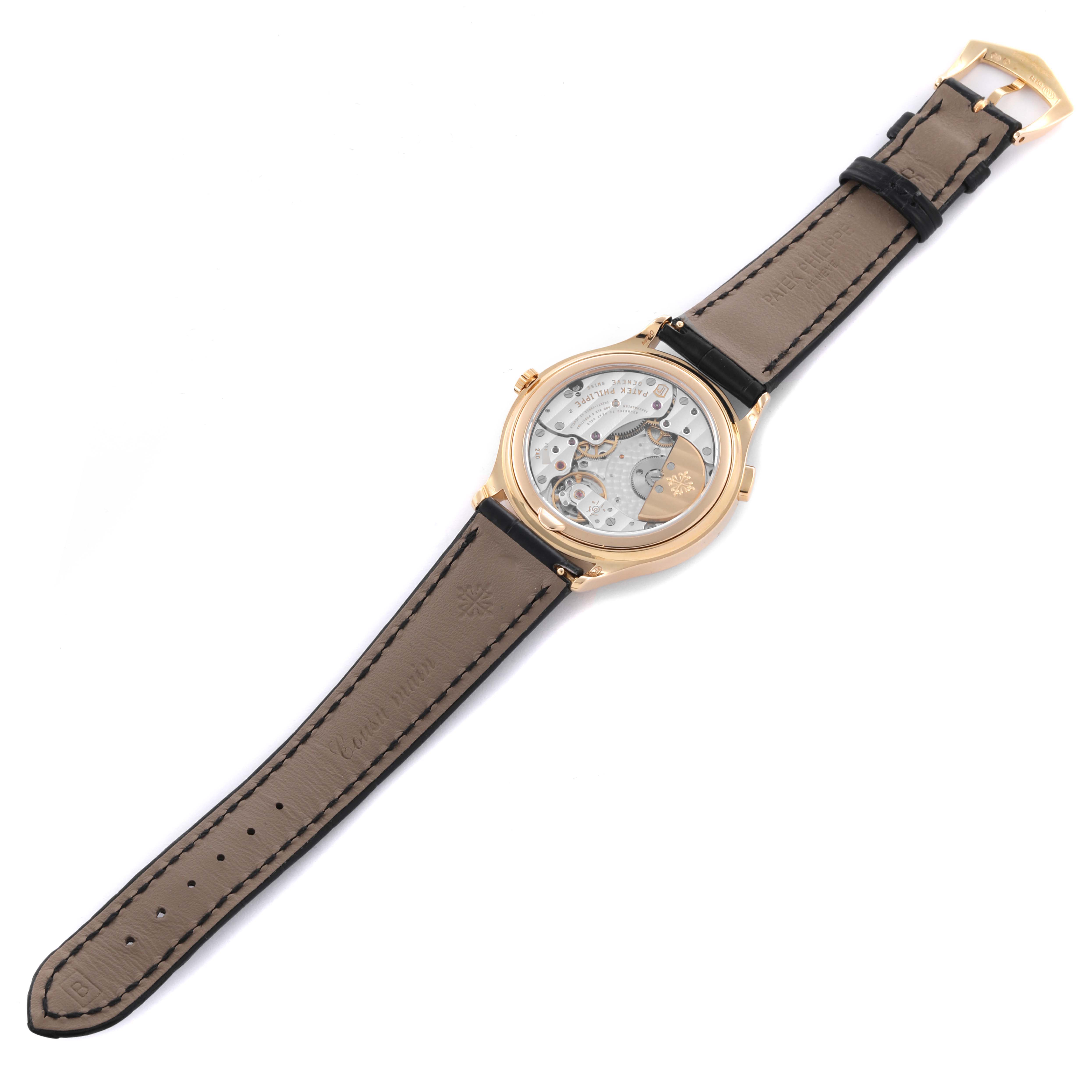 The Patek Philippe Complications 7130R-013 Men's Rose Gold Silver Dial 7130R-013 Men's Rose Gold Silver Dial watch is shown from the back, revealing the movement and strap.