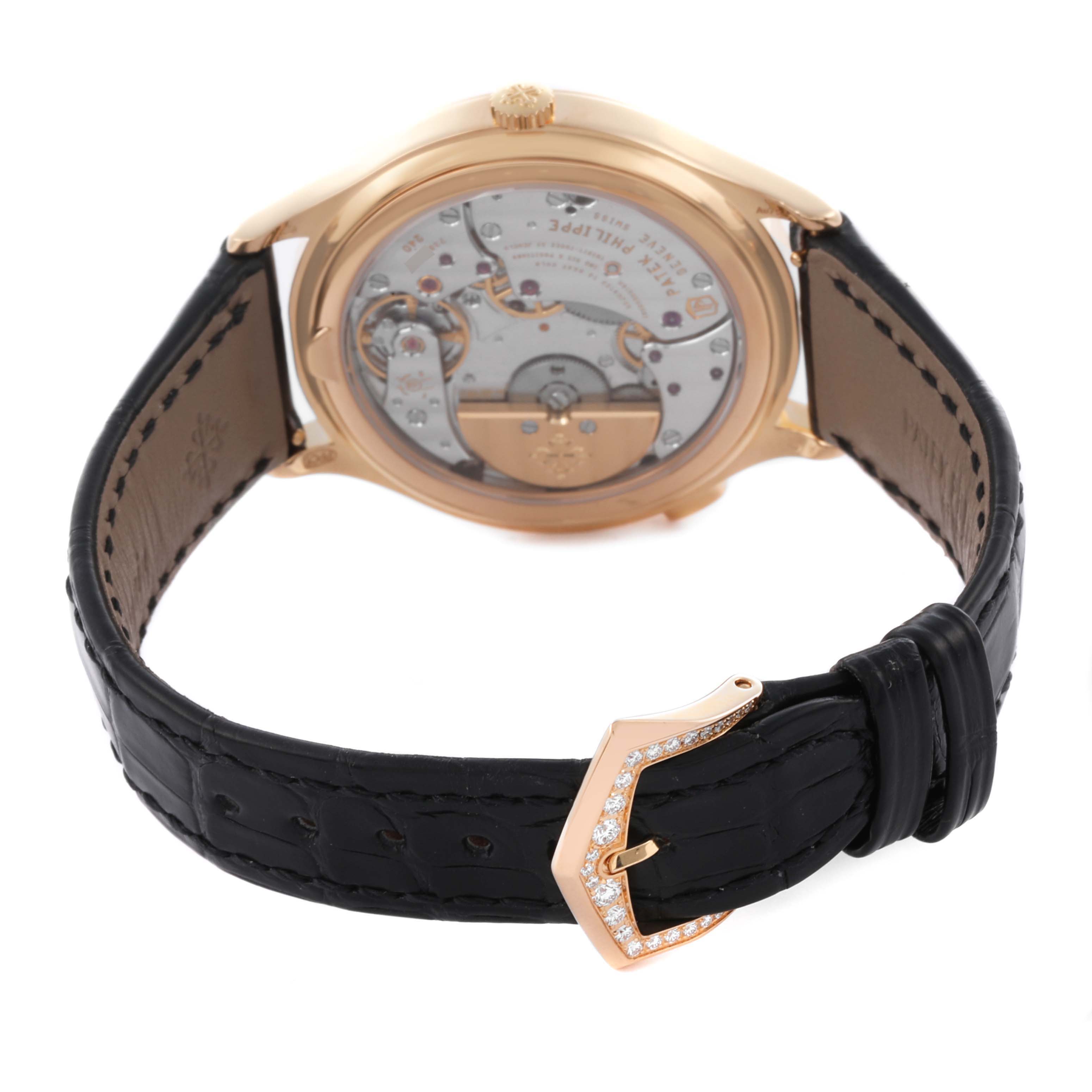 The image shows the back of a Patek Philippe Complications 7130R-013 Men's Rose Gold Silver Dial 7130R-013 Men's Rose Gold Silver Dial watch and its detailed movement, along with a black strap and diamond-set buckle.