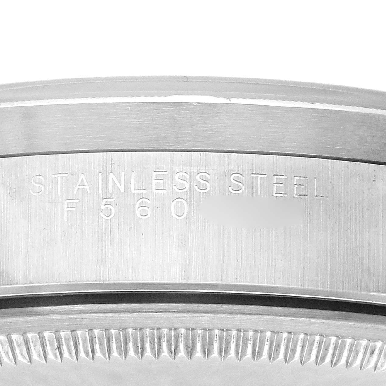 The image shows a close-up of the Rolex Air-King 14010M Men's Stainless Steel Black Dial 14010M Men's Stainless Steel Black Dial's stainless steel case with engraved text details.