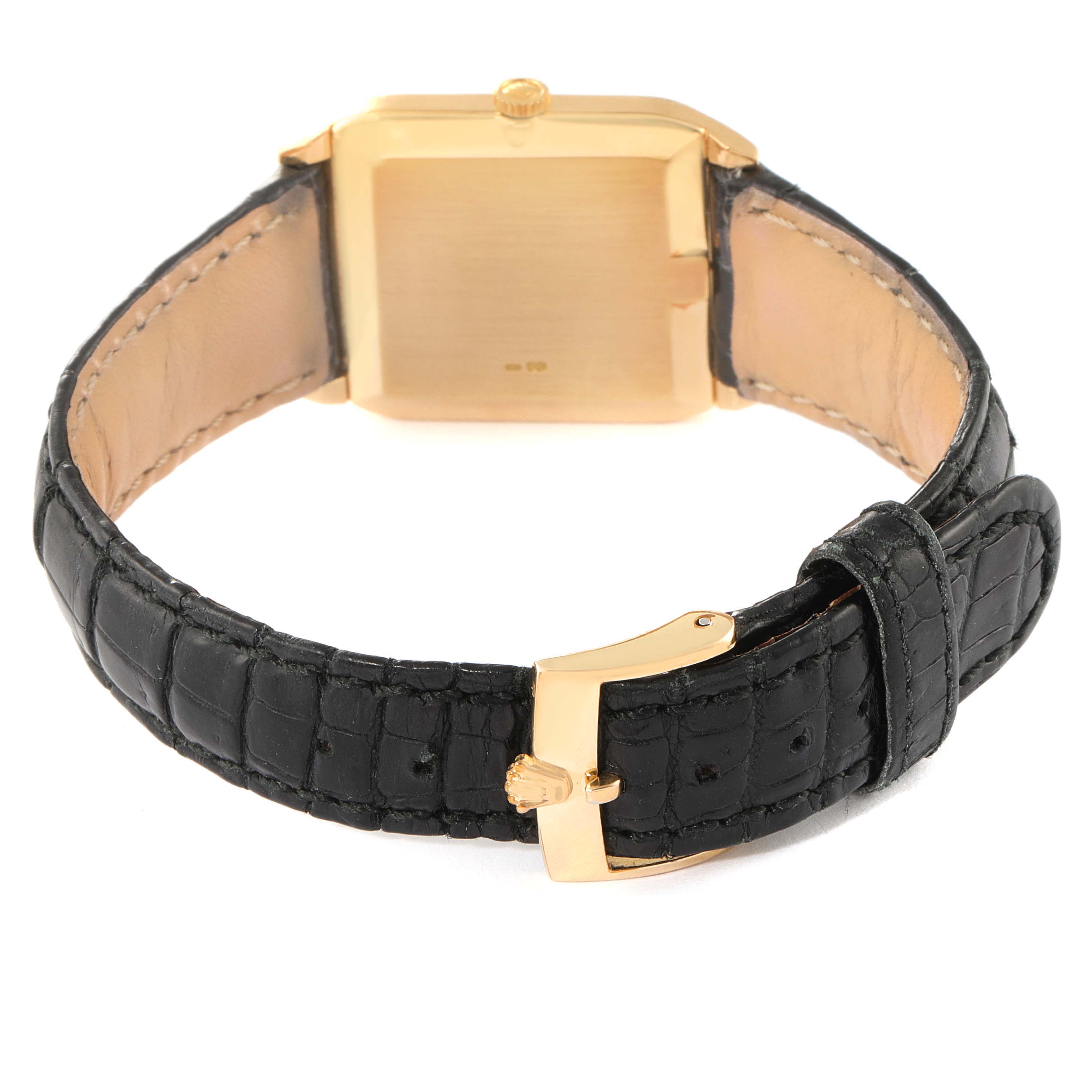 The image shows the rear of a Rolex Cellini 4135 Men's Yellow Gold Champagne Dial 4135 Men's Yellow Gold Champagne Dial watch, focusing on the gold case back and the black leather strap with a gold buckle.