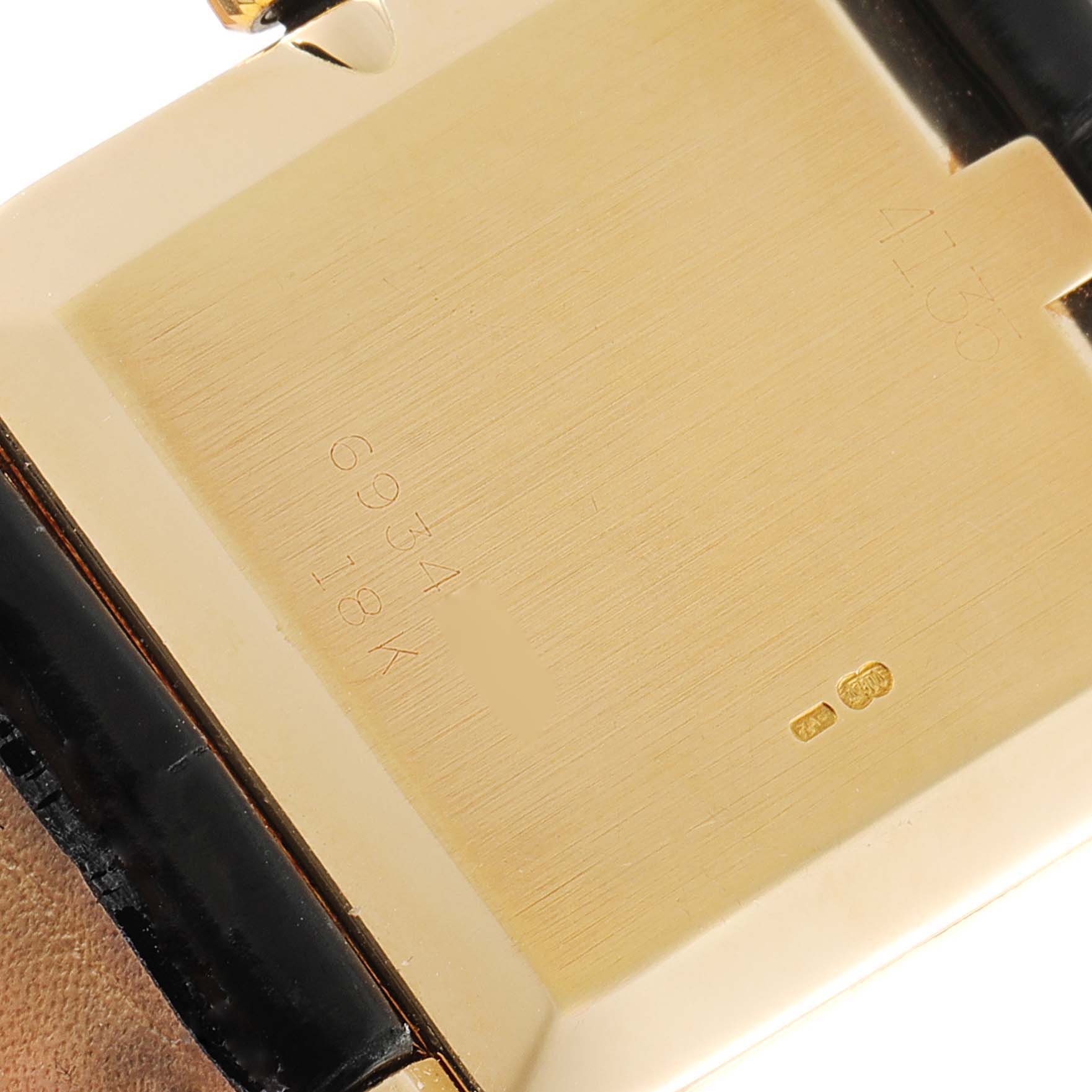 The image shows the back case and part of the strap of a Rolex Cellini 4135 Men's Yellow Gold Champagne Dial 4135 Men's Yellow Gold Champagne Dial watch, highlighting the engraved model number and material.