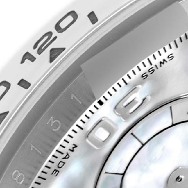 The image shows a close-up of the bezel and partial dial of a Rolex Daytona 116509 Men
s White Gold Mother of Pearl Dial 116509 Men
s White Gold Mother of Pearl Dial watch.