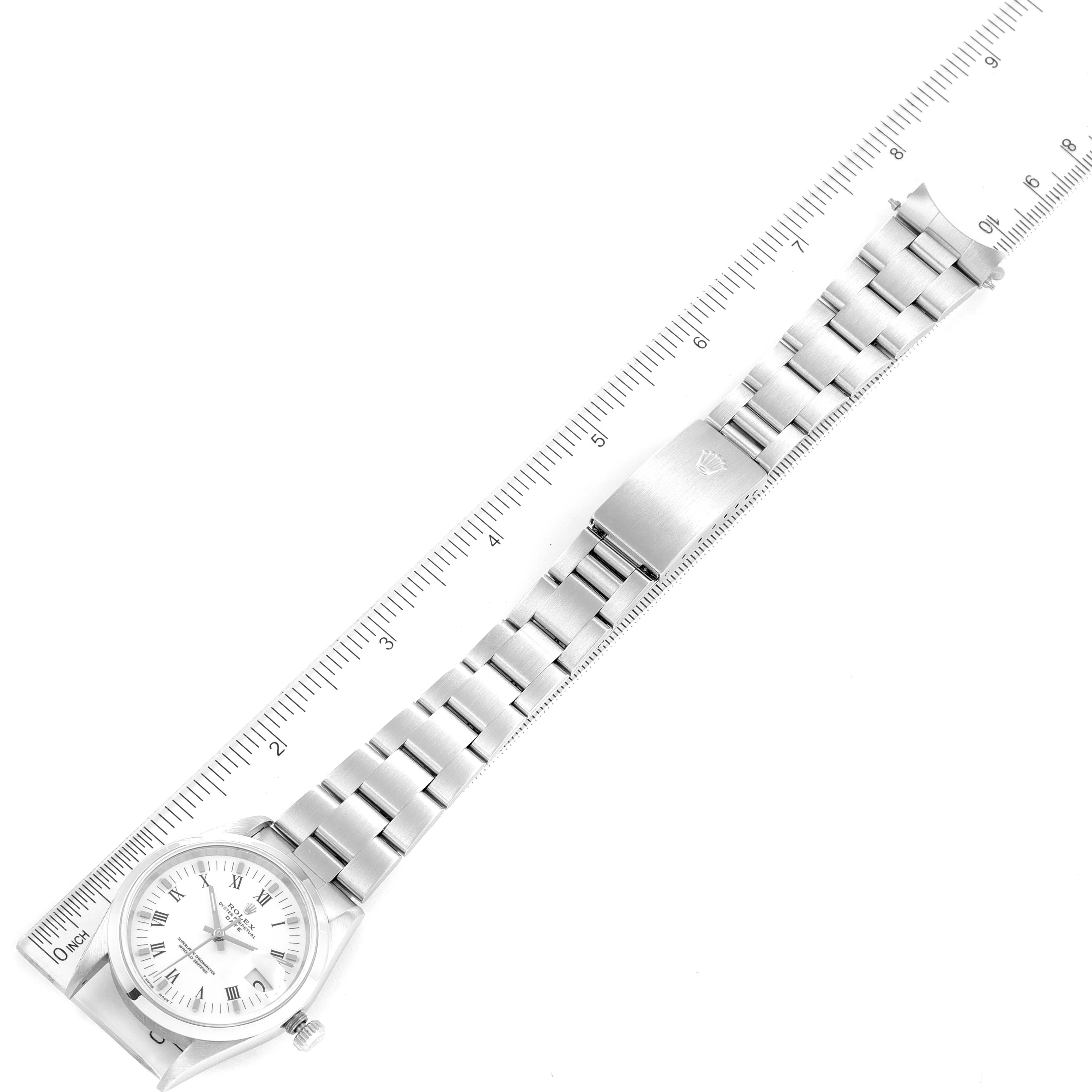 The image shows a top view of a Rolex Date 15200 Men's Stainless Steel White Dial 15200 Men's Stainless Steel White Dial watch with its bracelet and clasp, alongside a measuring scale.