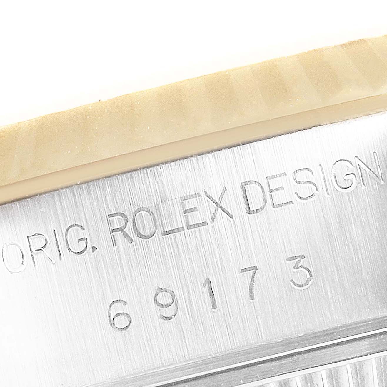 Close-up of the serial number and engraved text on the case side of a Rolex Datejust 69173 Women
s Steel and Gold (two tone) Champagne Dial 69173 Women
s Steel and Gold (two tone) Champagne Dial watch model.