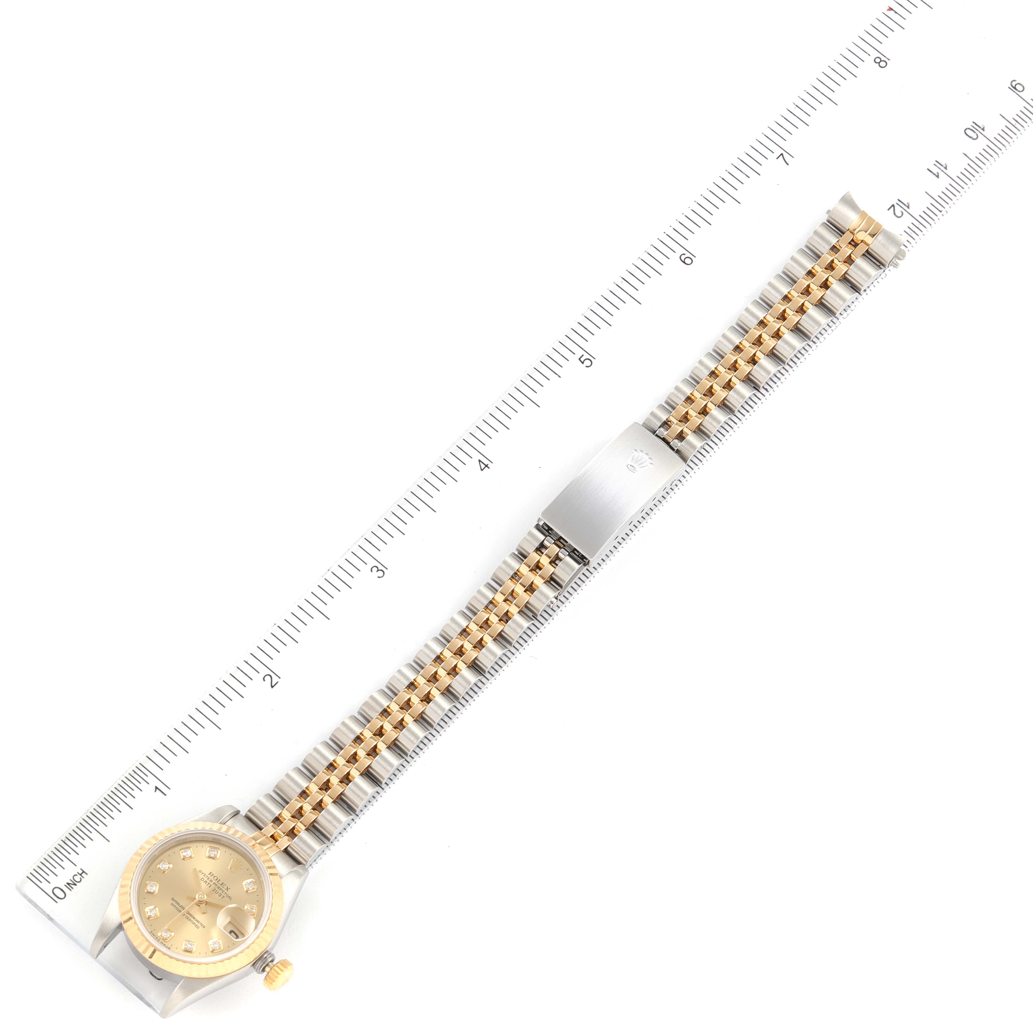 The Rolex Datejust 69173 Women
s Steel and Gold (two tone) Champagne Dial 69173 Women
s Steel and Gold (two tone) Champagne Dial watch is shown fully extended, laid flat next to a ruler for measurement.