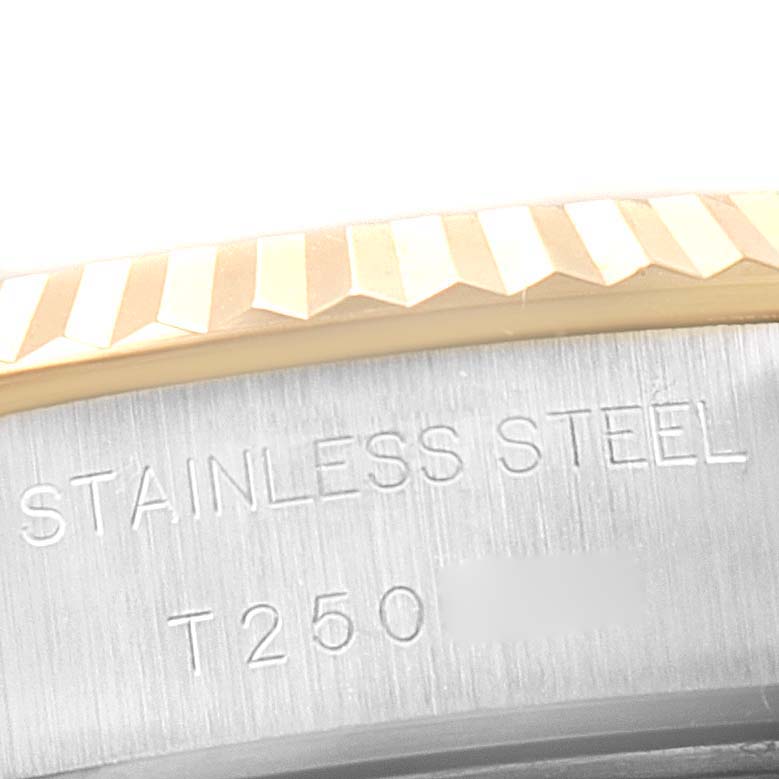 This image shows a close-up angle of the bezel and side case of the Rolex Datejust 69173 Women
s Steel and Gold (two tone) Champagne Dial 69173 Women
s Steel and Gold (two tone) Champagne Dial watch, highlighting the "Stainless Steel" engraving.