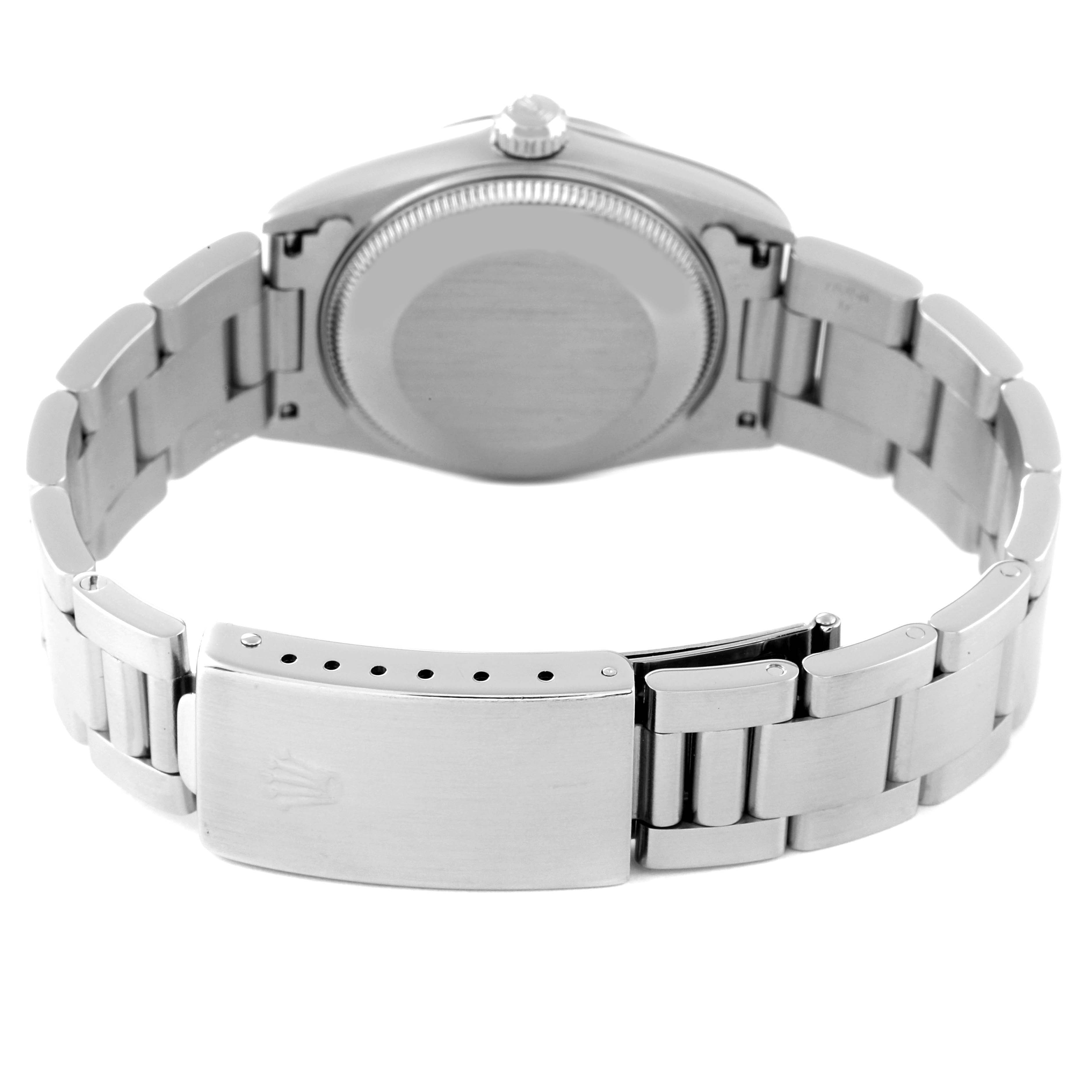 The image shows the back view and bracelet of a Mid-Size Rolex watch, highlighting its clasp and case back.