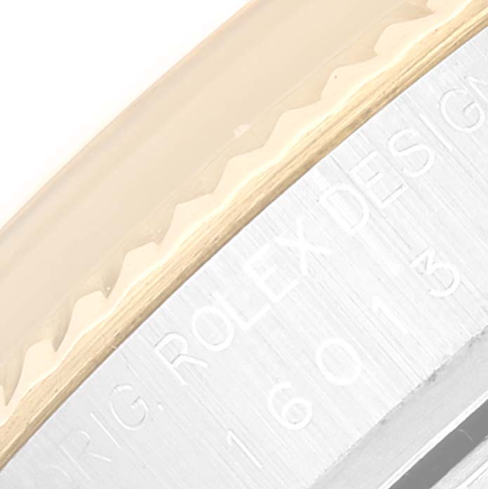 This image shows a close-up of the bezel and engraved side of a Rolex Datejust 16013 Men's Steel and Gold (two tone) Champagne Dial 16013 Men's Steel and Gold (two tone) Champagne Dial watch case.