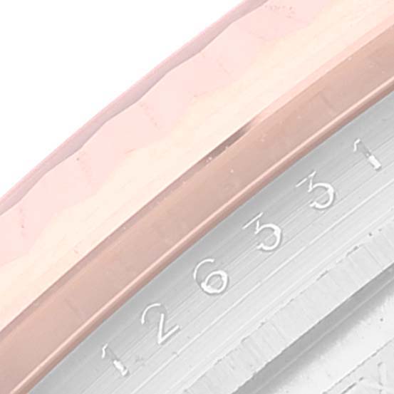 This image shows a close-up of the fluted bezel and date display of a Rolex Datejust 41 126331 Men's Steel and Gold (two tone) Brown Dial 126331 Men's Steel and Gold (two tone) Brown Dial watch.