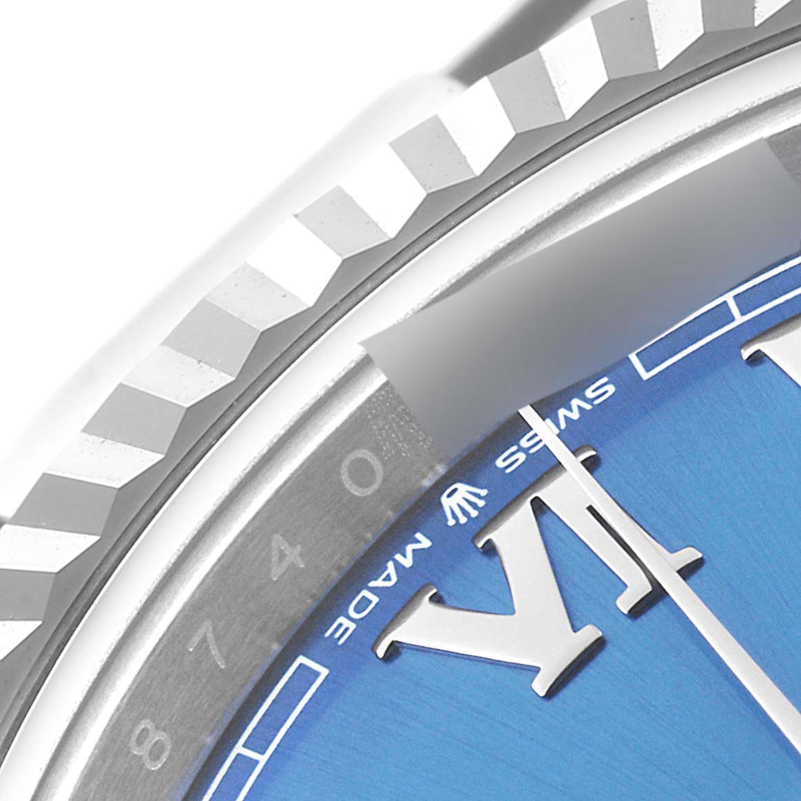 This close-up image of the Rolex Datejust 41 126334 Men's Stainless Steel Blue Dial 126334 Men's Stainless Steel Blue Dial shows the fluted bezel, part of the blue dial, and the "SWISS MADE" text.