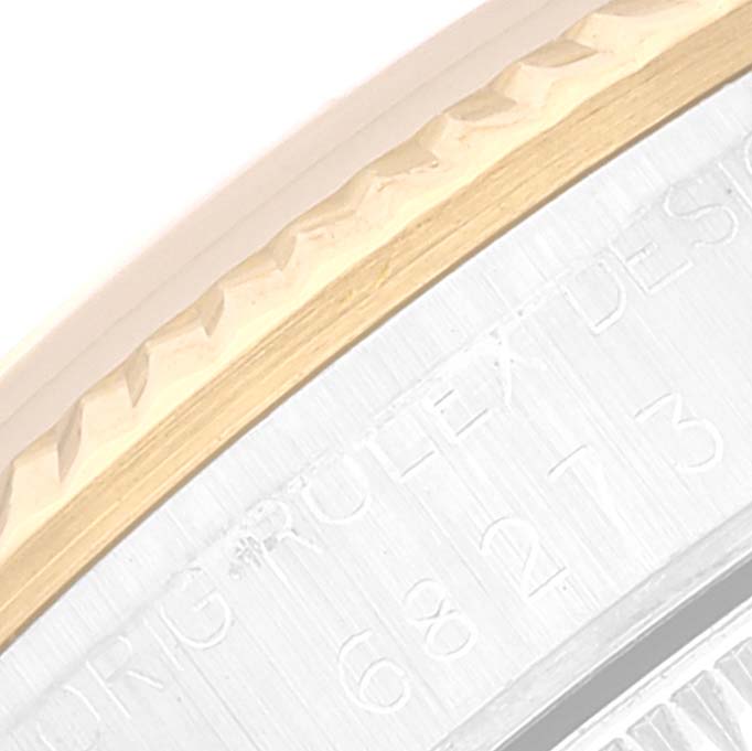 This image shows a close-up of the side casing and edge of the bezel on a Mid-Size Rolex watch.