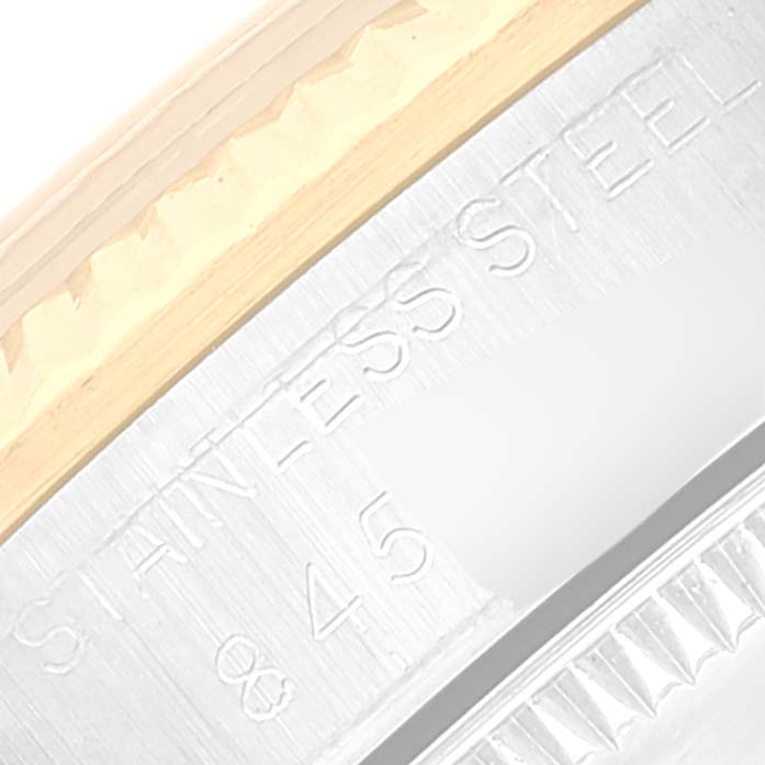 This is a close-up of the side of a Mid-Size Rolex watch, showing "STAINLESS STEEL" engraved on the bezel edge.