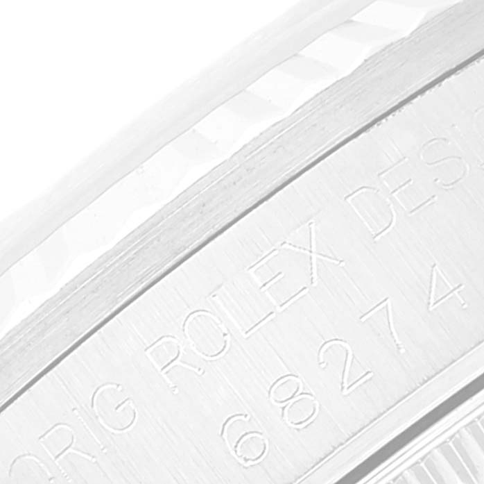 The image shows a close-up of the engraved case back of a Mid-Size Rolex watch from an angled perspective.