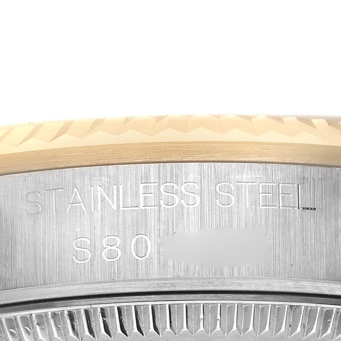 The image shows a close-up of the side of a Rolex Mid-Size 68273 Women's Steel and Gold (two tone) Champagne Dial 68273 Women's Steel and Gold (two tone) Champagne Dial watch with "STAINLESS STEEL" and part of the case visible.