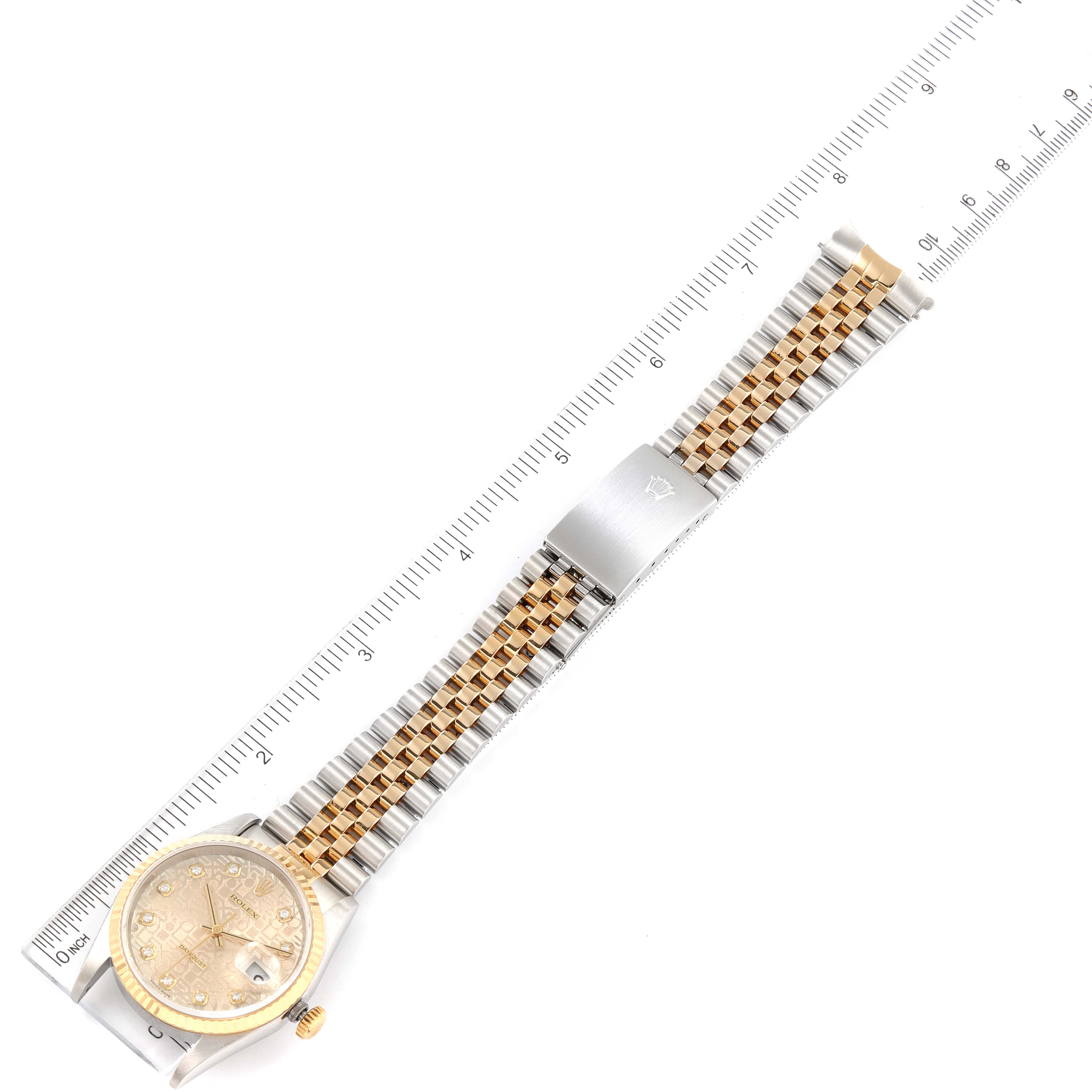 The image shows a Rolex Datejust 16233 Men
s Steel and Gold (two tone) Silver Dial 16233 Men
s Steel and Gold (two tone) Silver Dial watch face-up with its full bracelet displayed alongside a measuring scale.