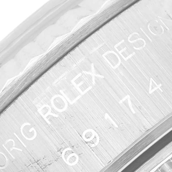 This is a close-up shot of the inner bezel of a Rolex Datejust 69174 Women's Stainless Steel Silver Dial 69174 Women's Stainless Steel Silver Dial watch, showing part of the engraved serial number and "ORIG ROLEX DESIGN."