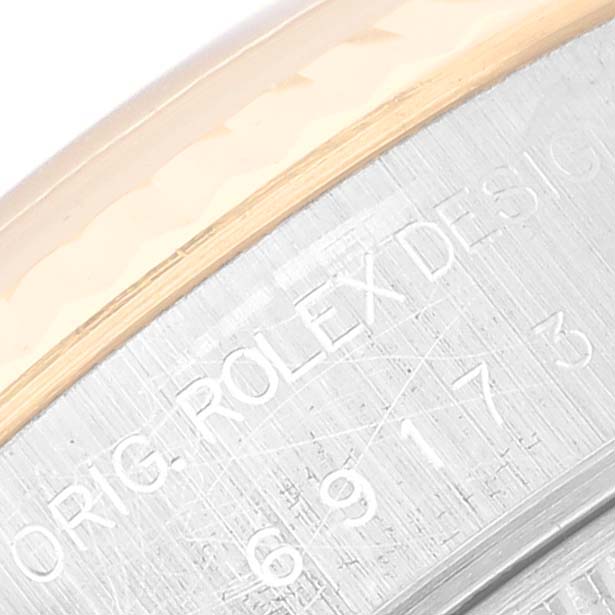 This close-up image of the Rolex Datejust 69173 Women's Steel and Gold (two tone) Champagne Dial 69173 Women's Steel and Gold (two tone) Champagne Dial model shows part of the bezel and the engraved side markings.